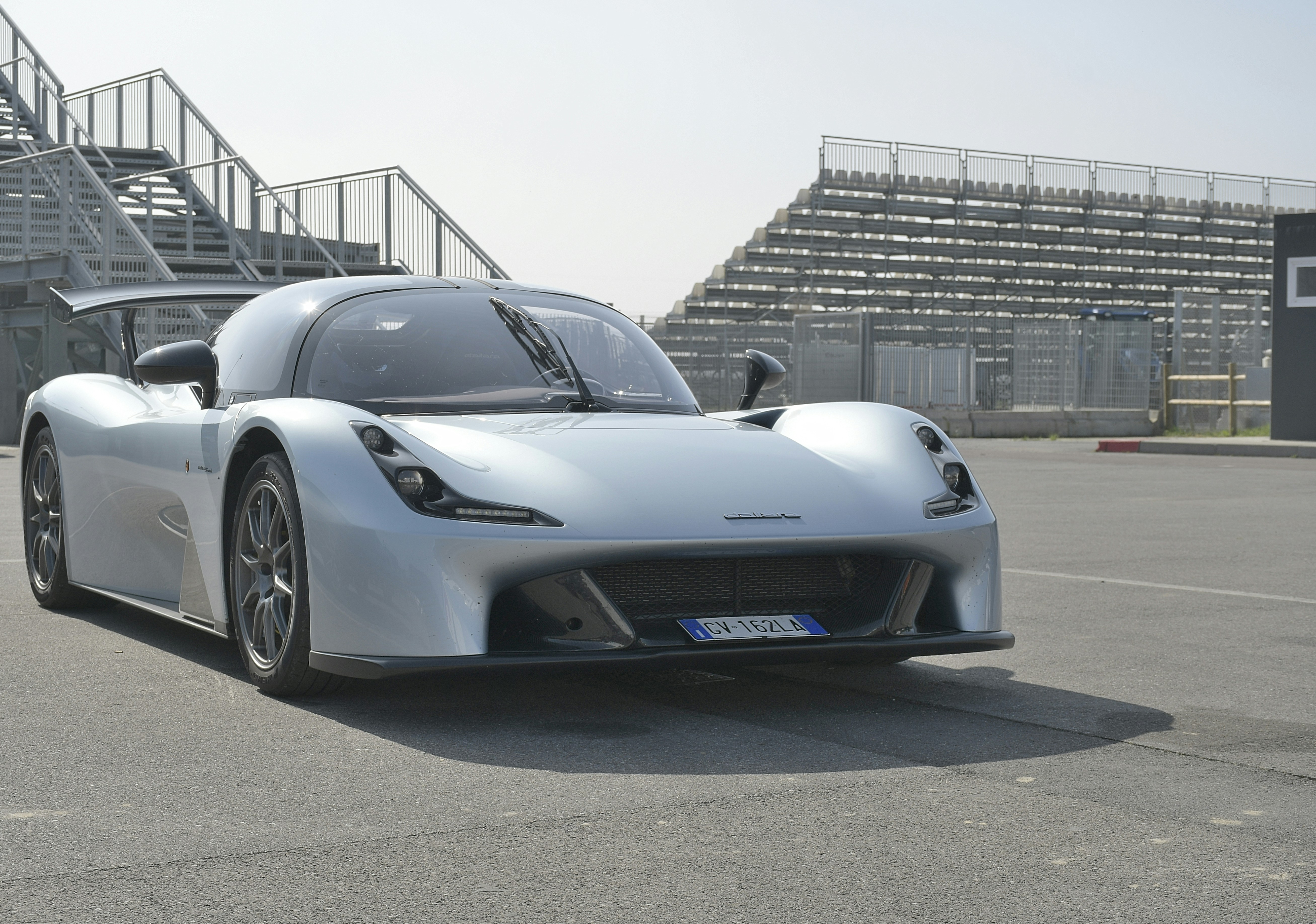 A silver sports car on a race track
