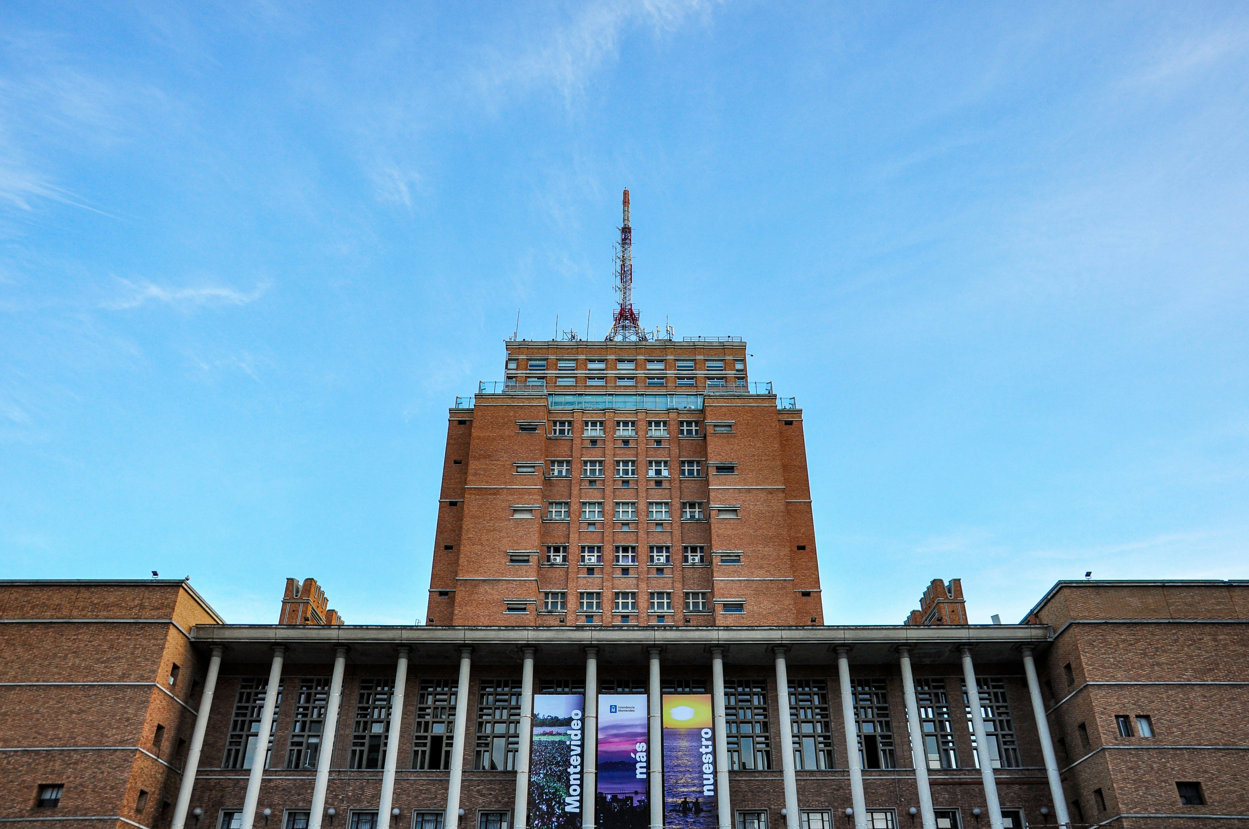Tall brick building with columns against blue sky