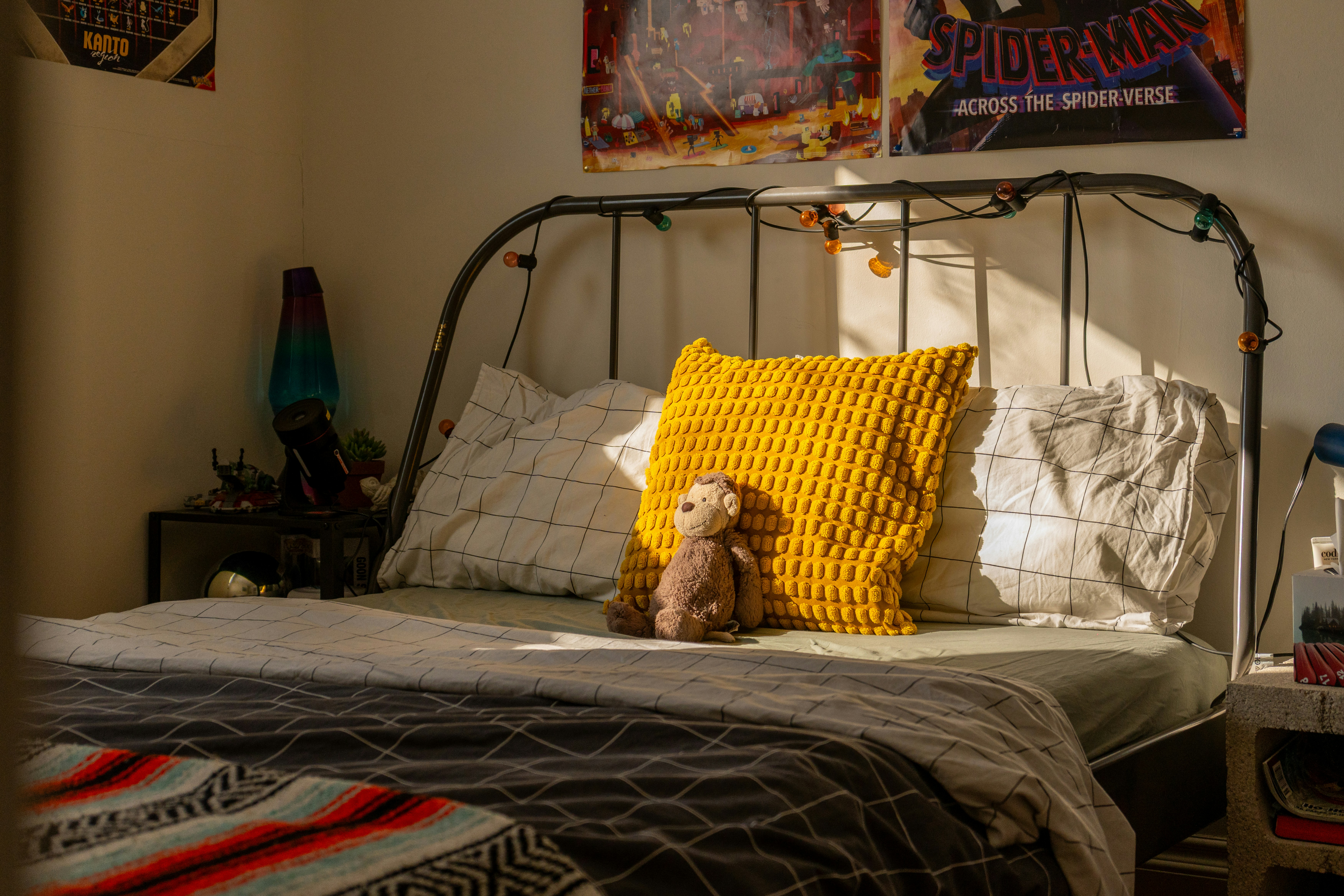 A child's bedroom with a bed and posters.