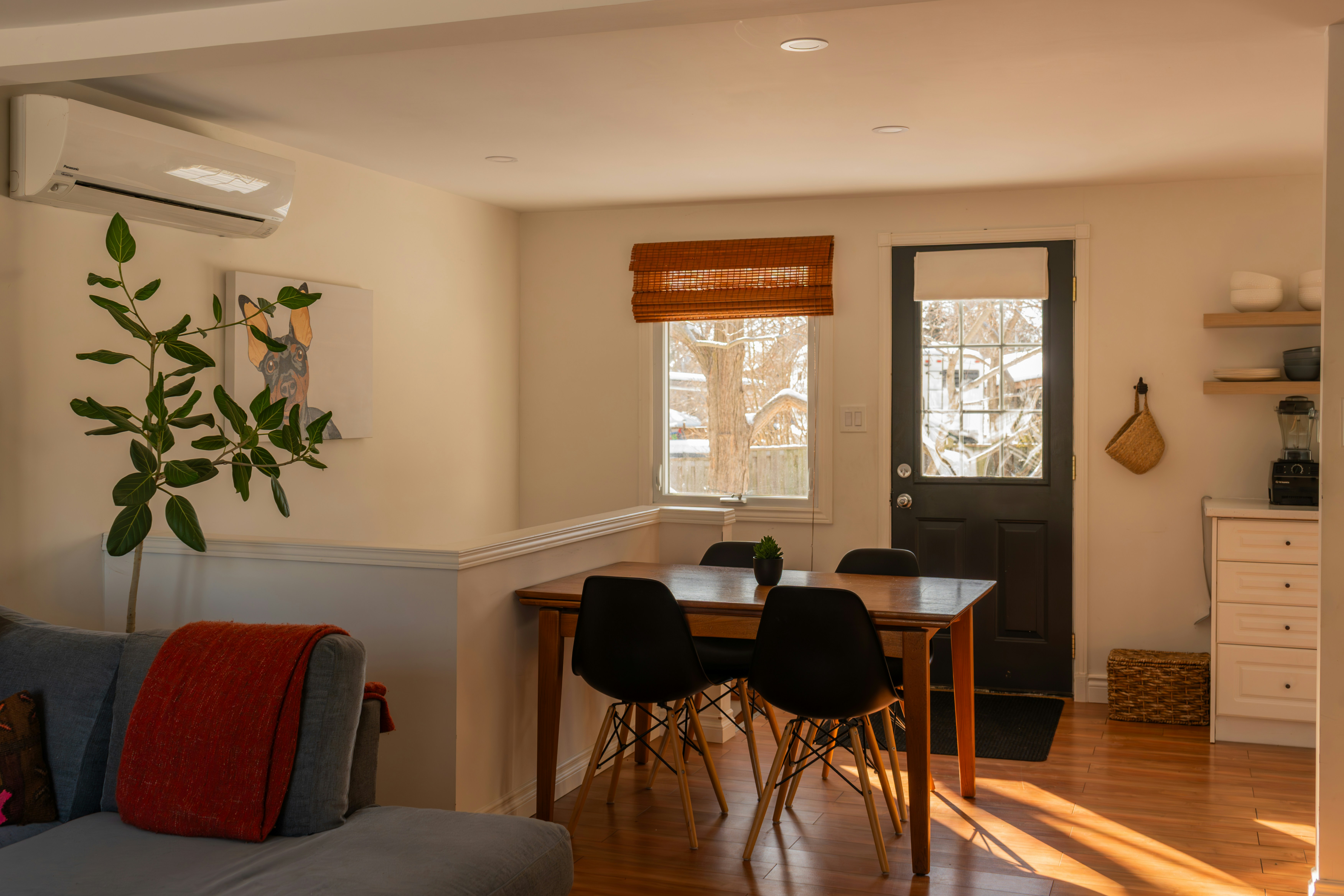 Dining area with table, chairs, and door.