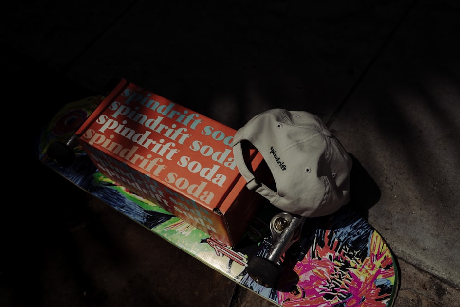 Spindrift soda box on a skateboard with a hat