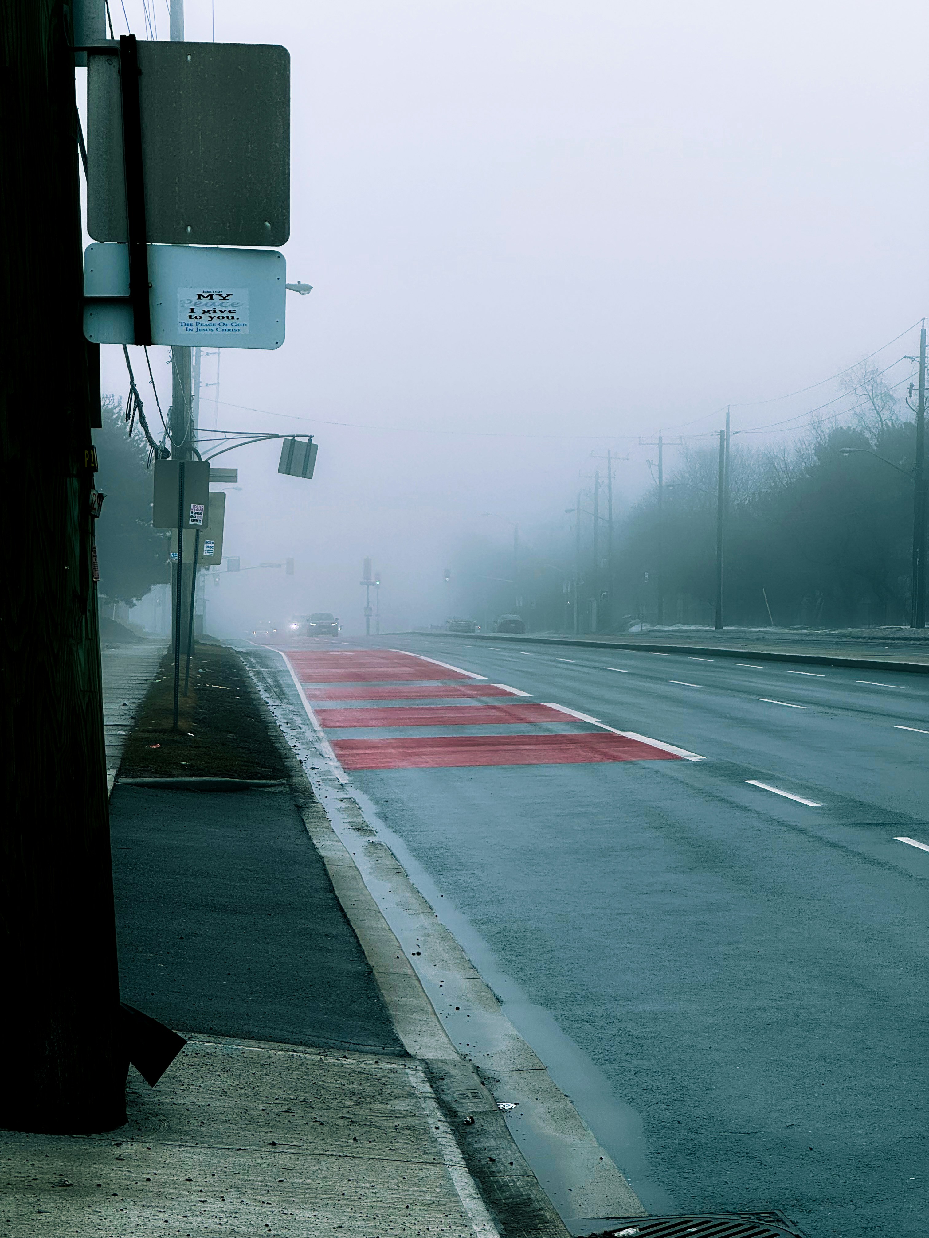 A foggy road with red markings on the pavement. photo – Free Road Image ...