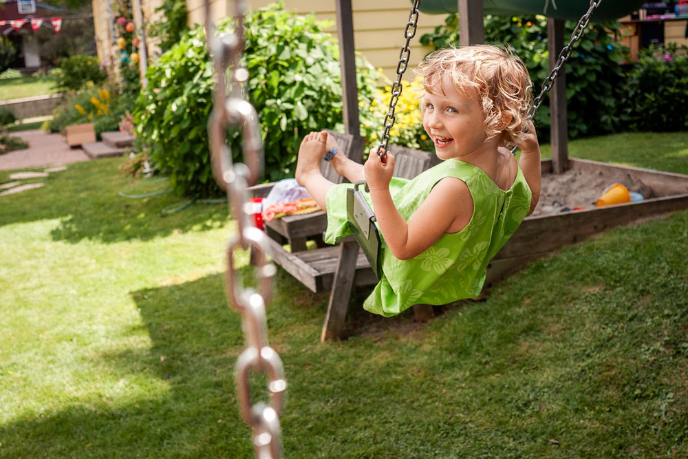 Girl smiling on a porch swing