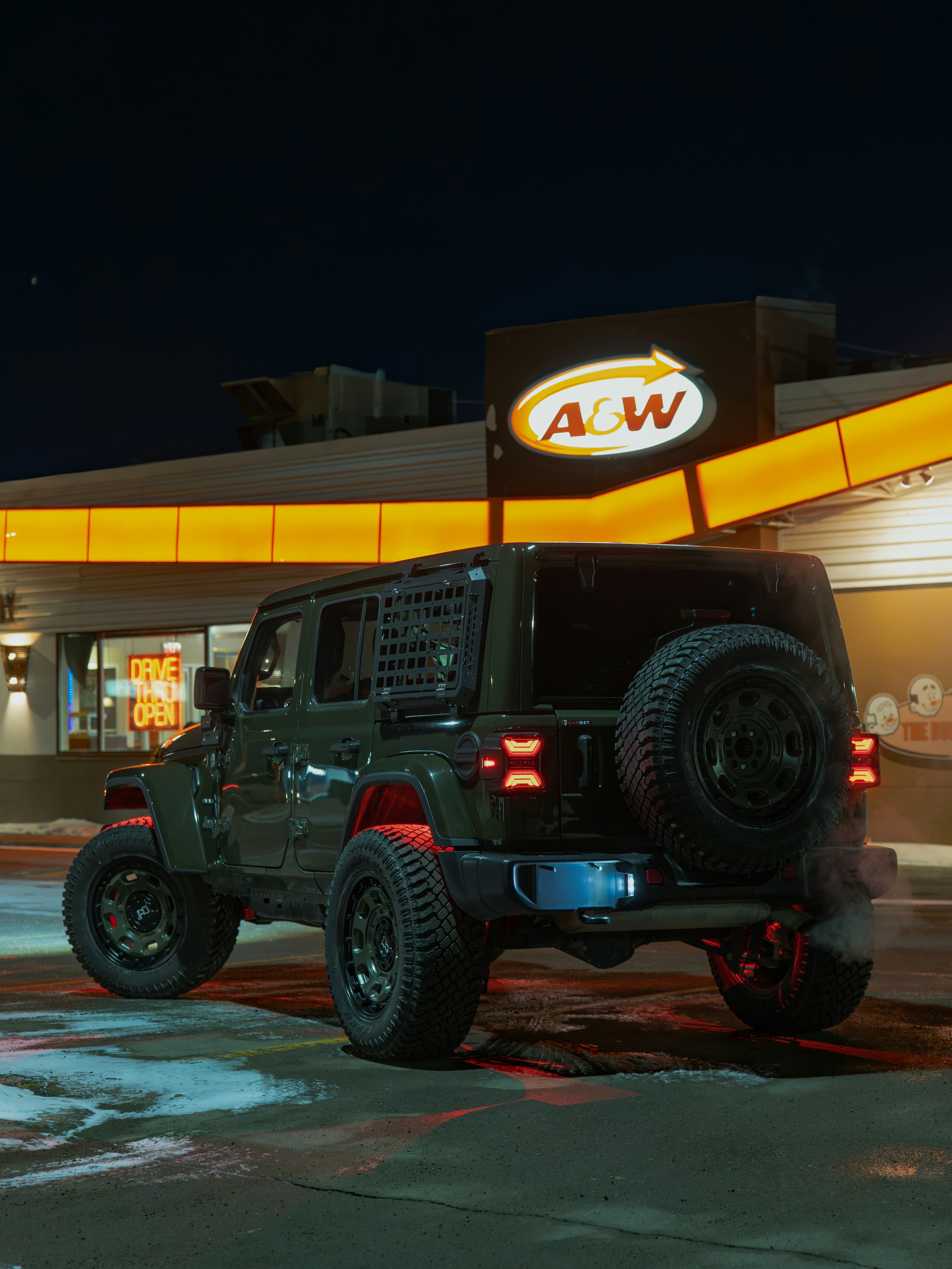 Dark jeep parked outside a&w at night
