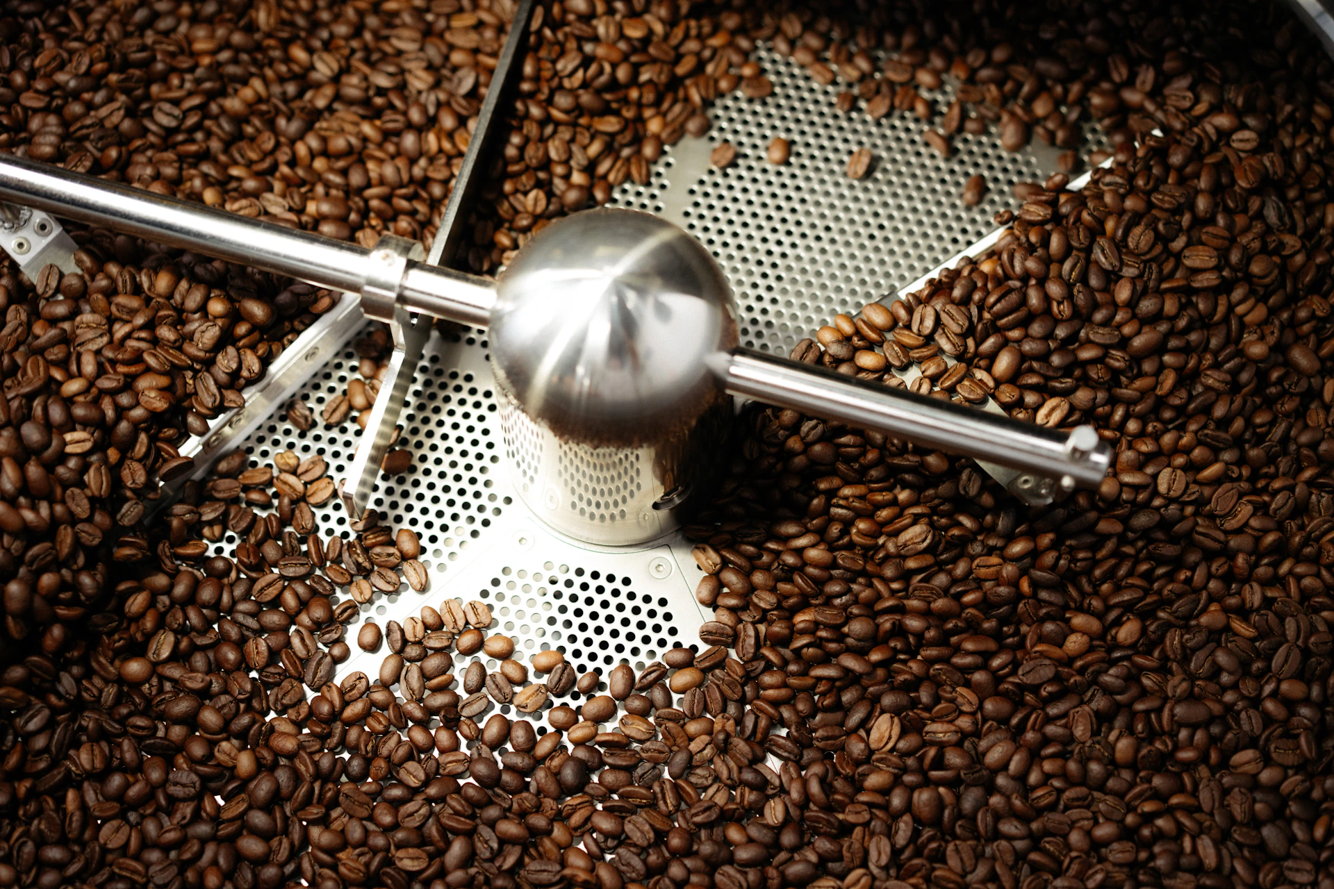 Coffee beans tumbling in a roasting machine.