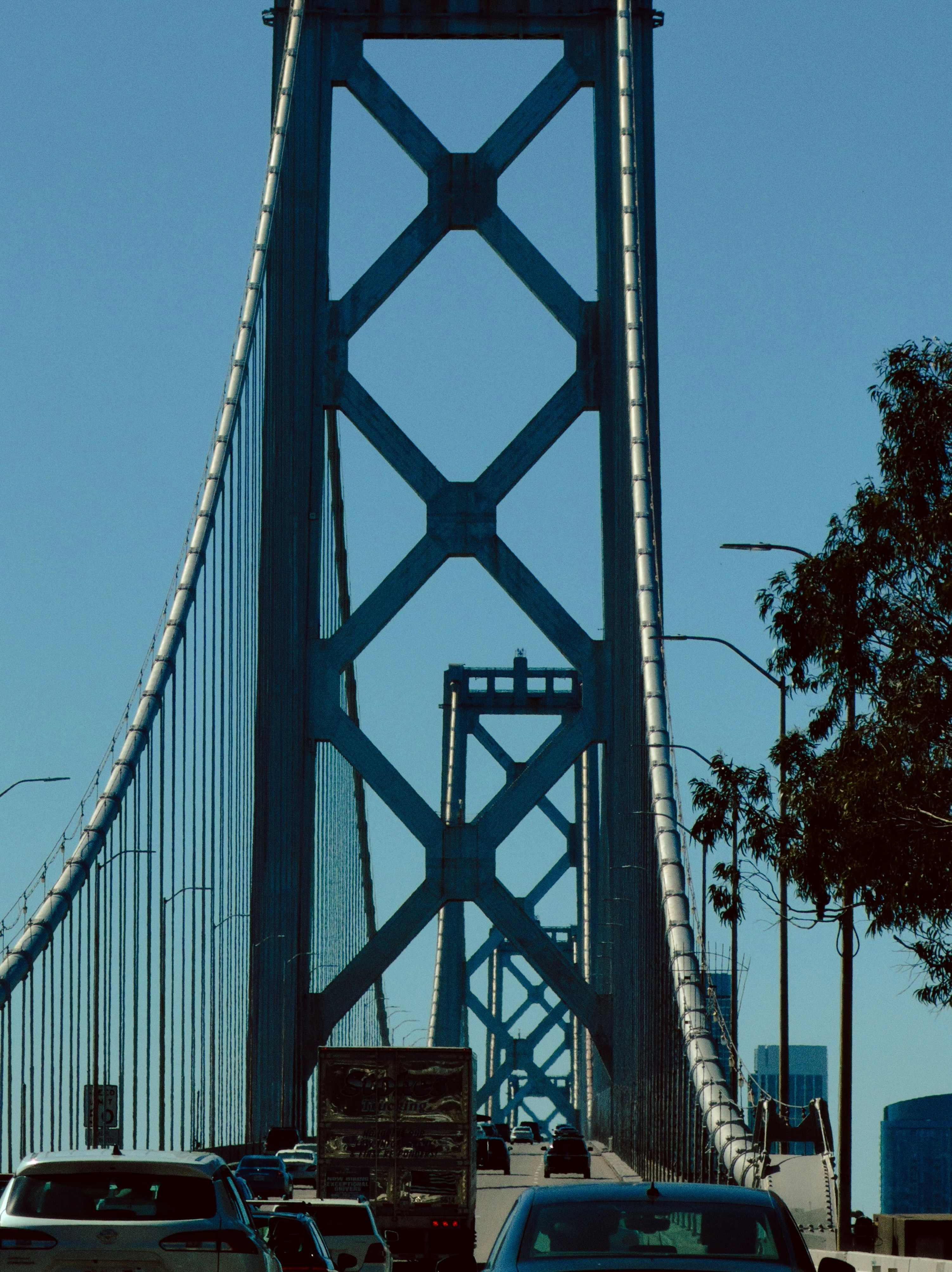 Traffic on a bridge under a clear blue sky