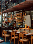 Cozy restaurant interior with wooden tables and chairs.