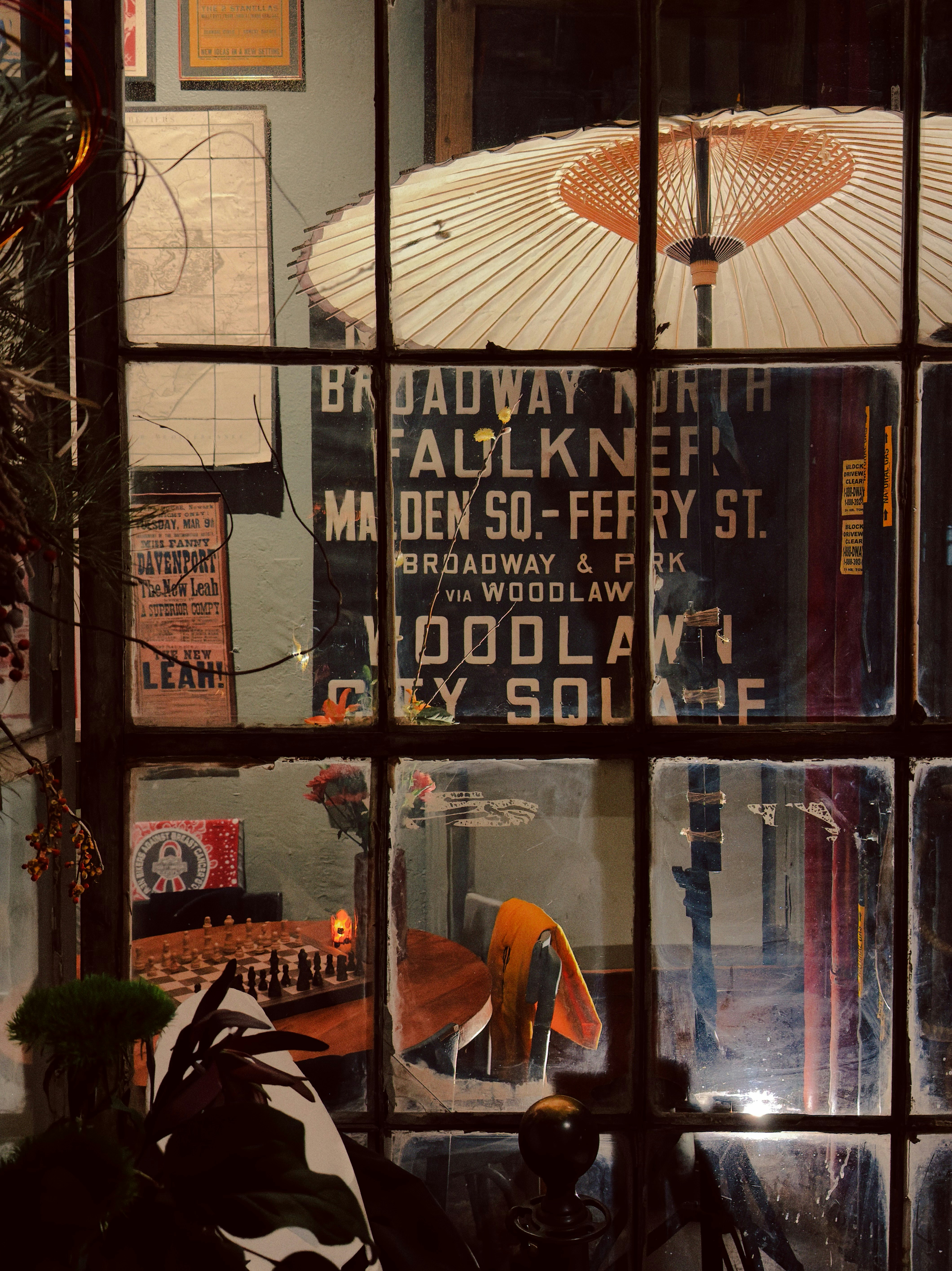 Vintage signs seen through a window at night.