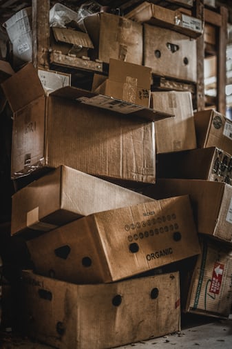 Pile of cardboard boxes stacked in a storage area