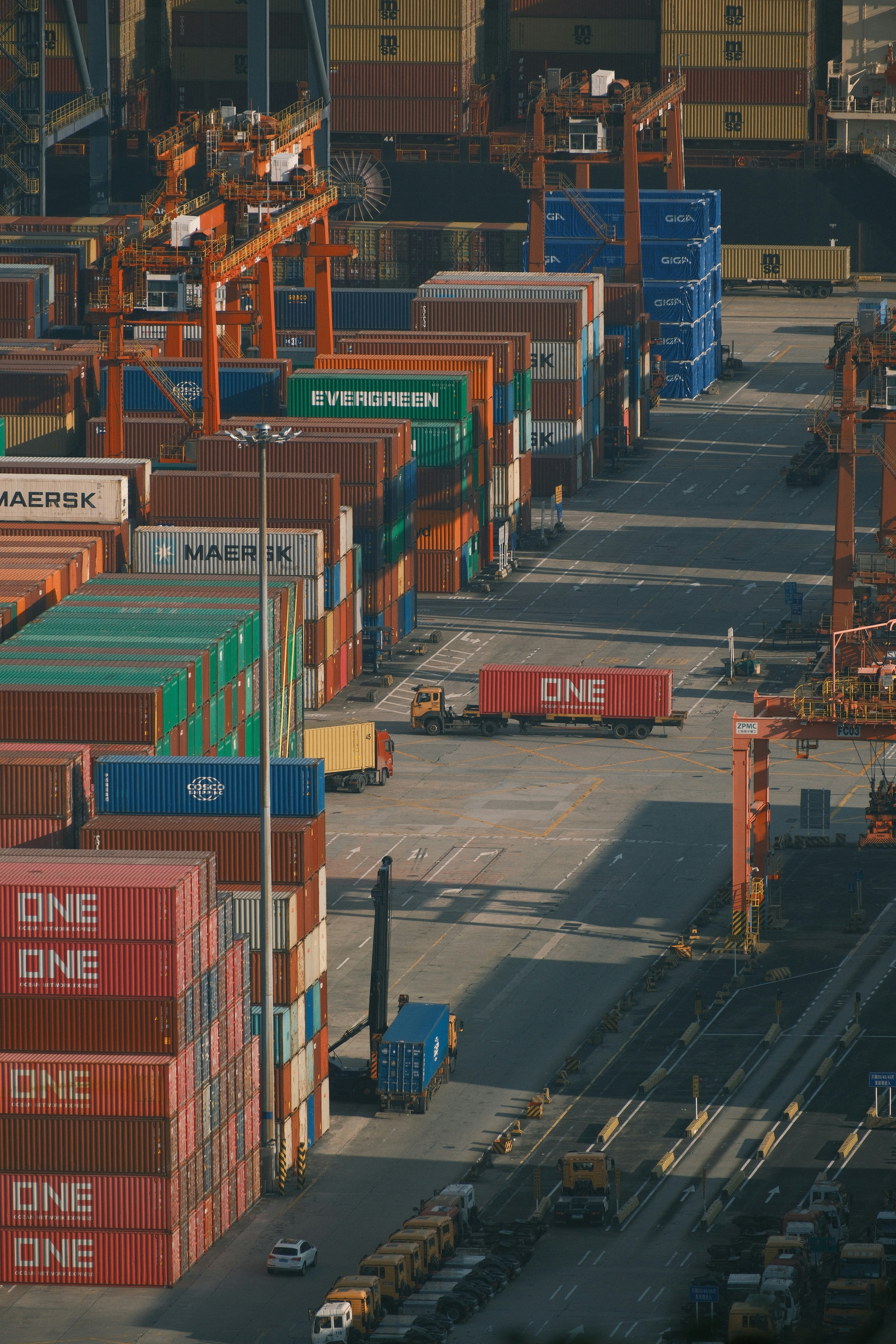 Shipping containers stacked high at a busy port.