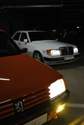 Two cars parked in a dimly lit garage