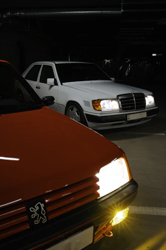 Two cars parked in a dimly lit garage