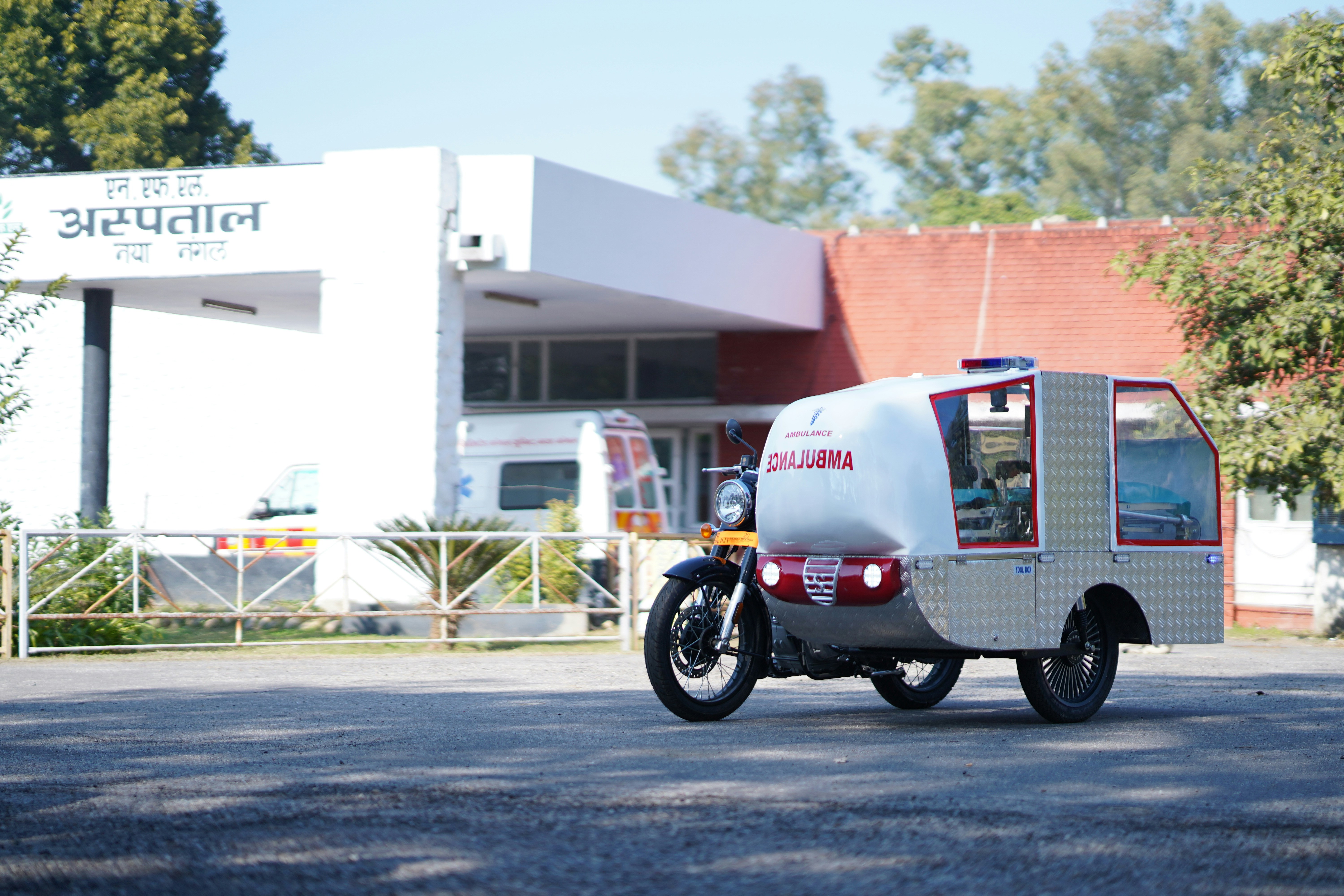 Ambulance vehicle parked outside hospital building.