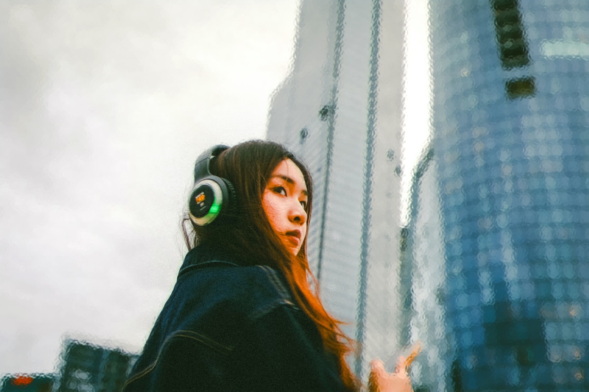 Young woman with headphones in a modern city