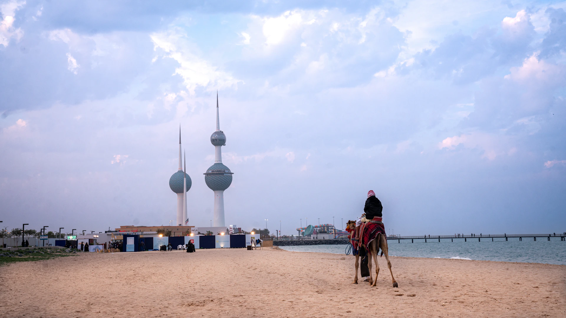 A person on a camel on a sandy beach