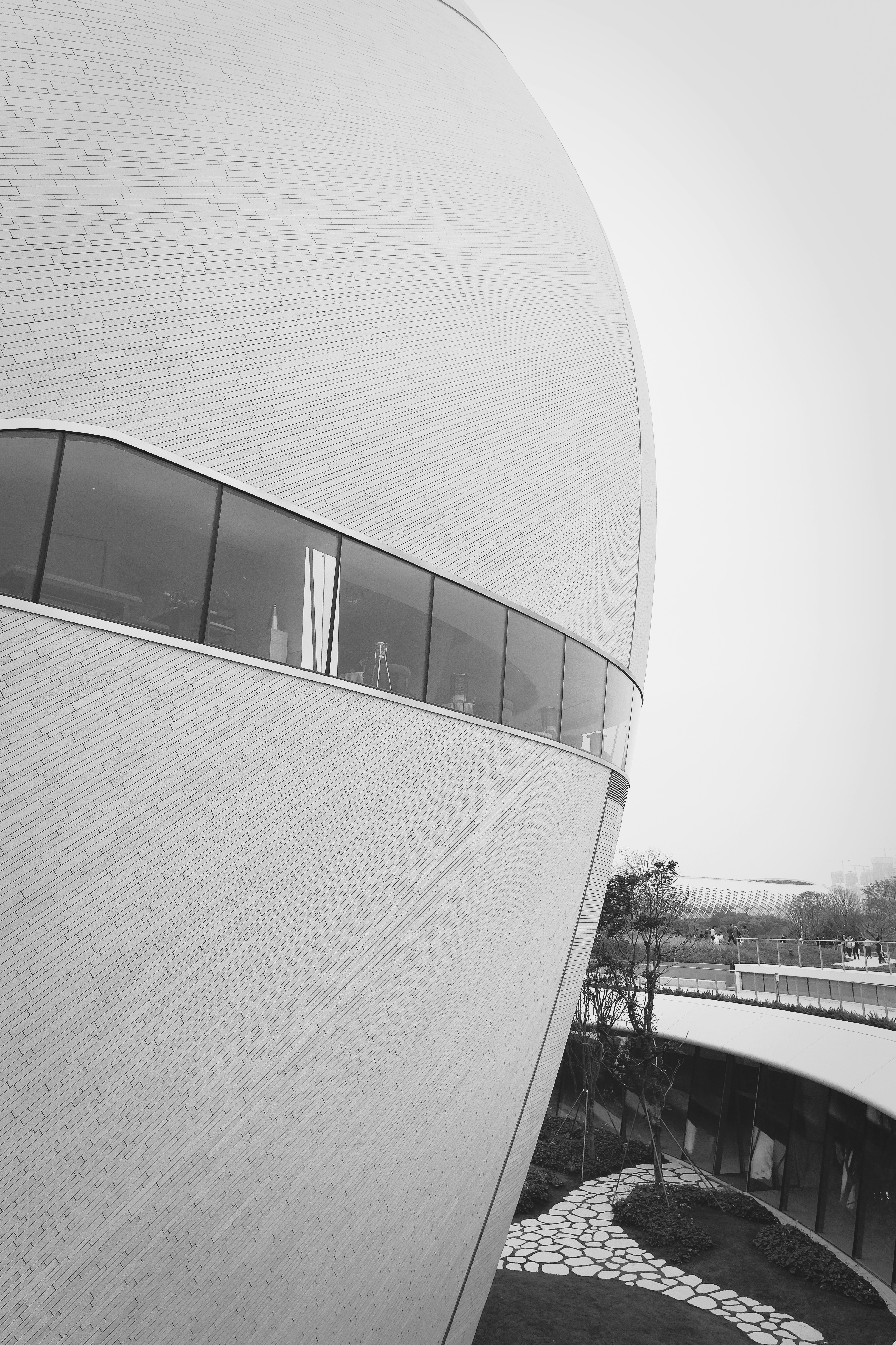 Modern curved building with a long horizontal window
