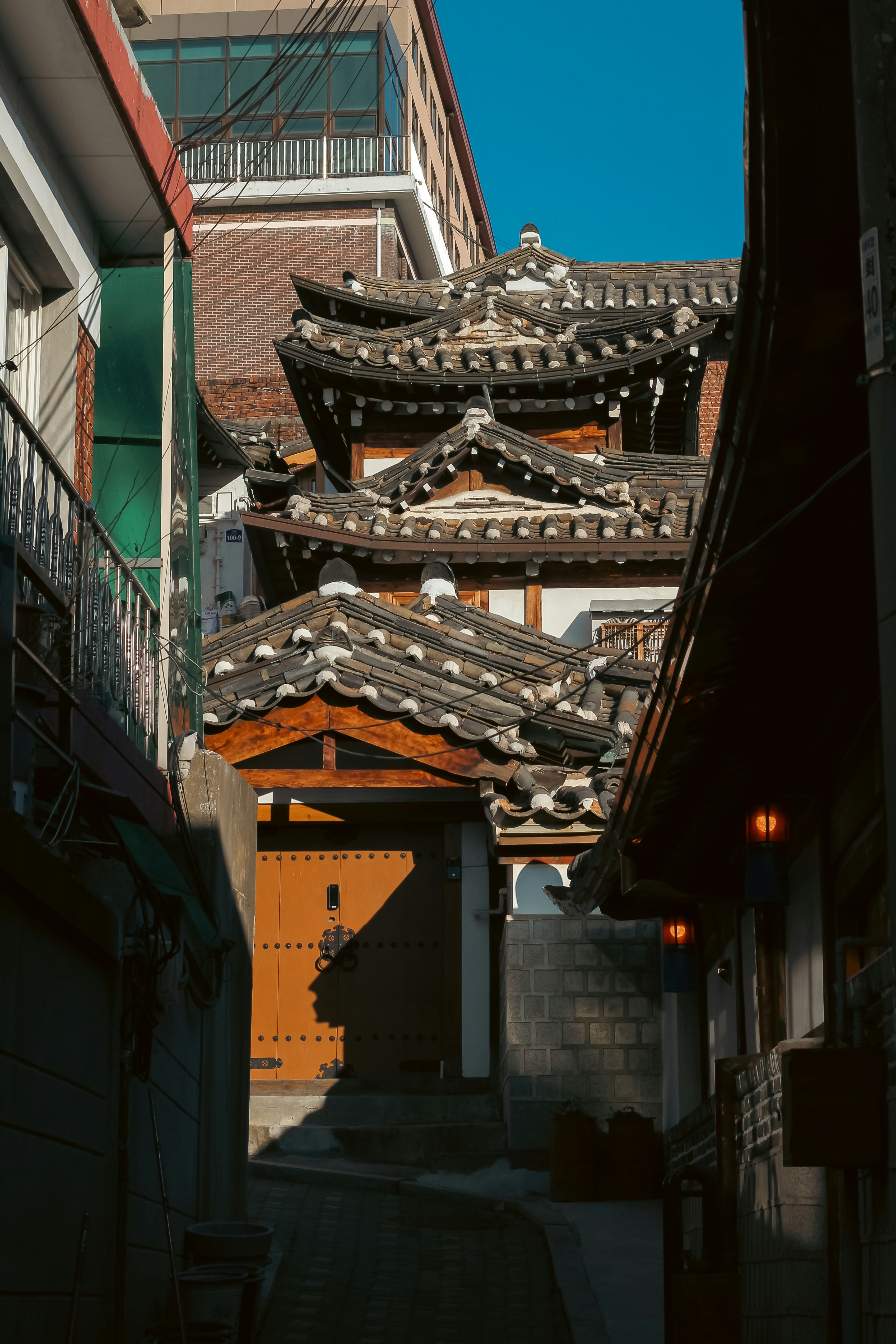 Traditional korean houses with tiled roofs in an alley.