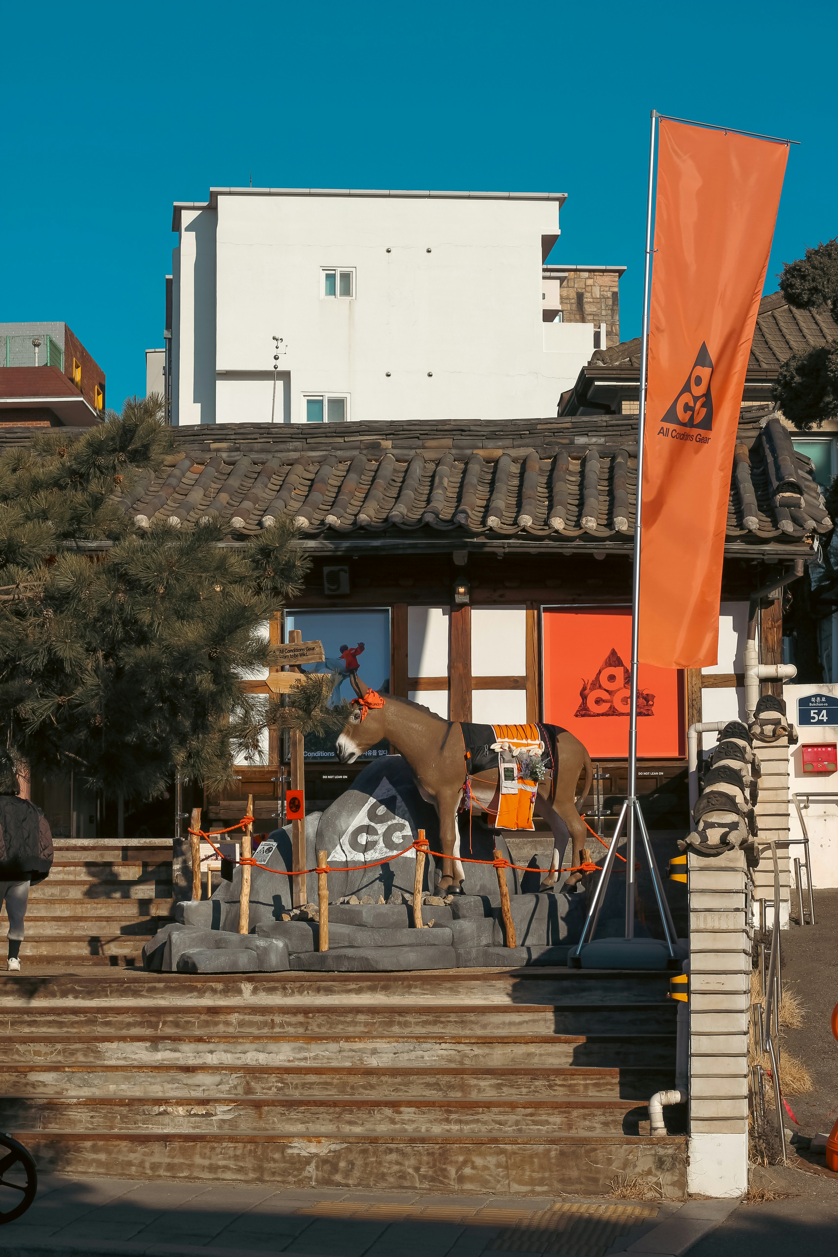 A statue of a horse with an orange flag