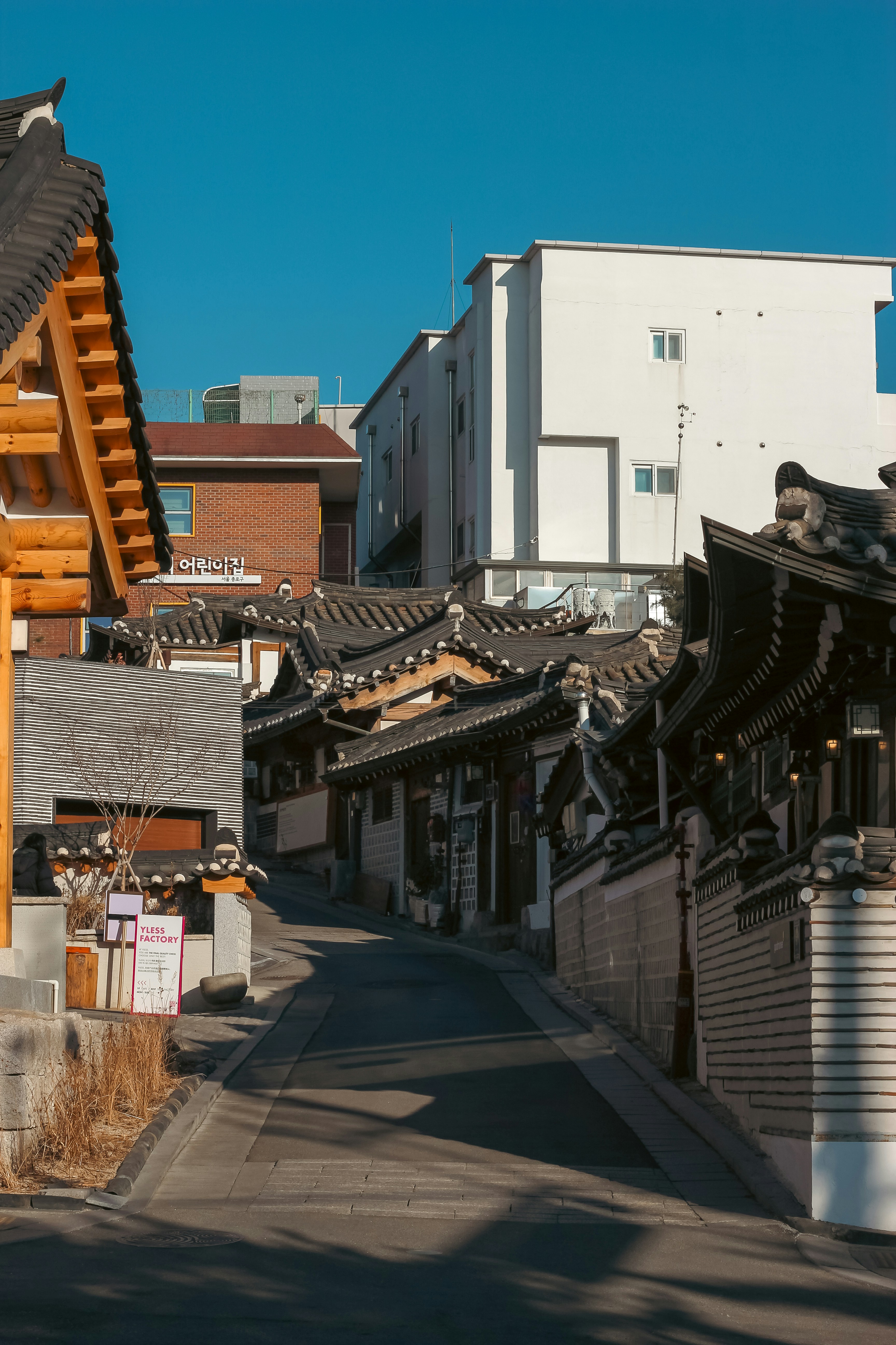 Traditional korean houses line a narrow street.