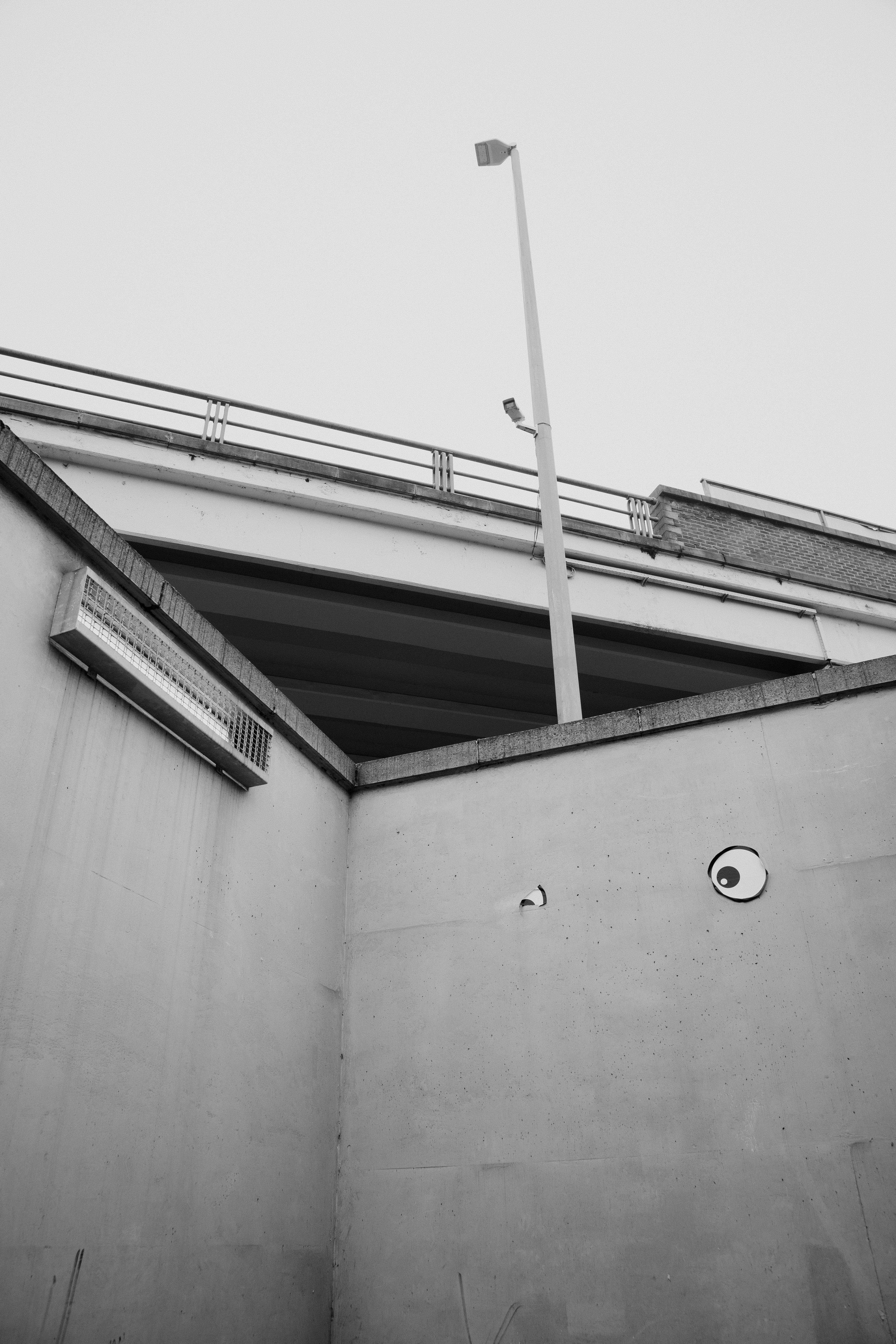 コンクリートの地下道に街灯と陰陽のシンボルがある。