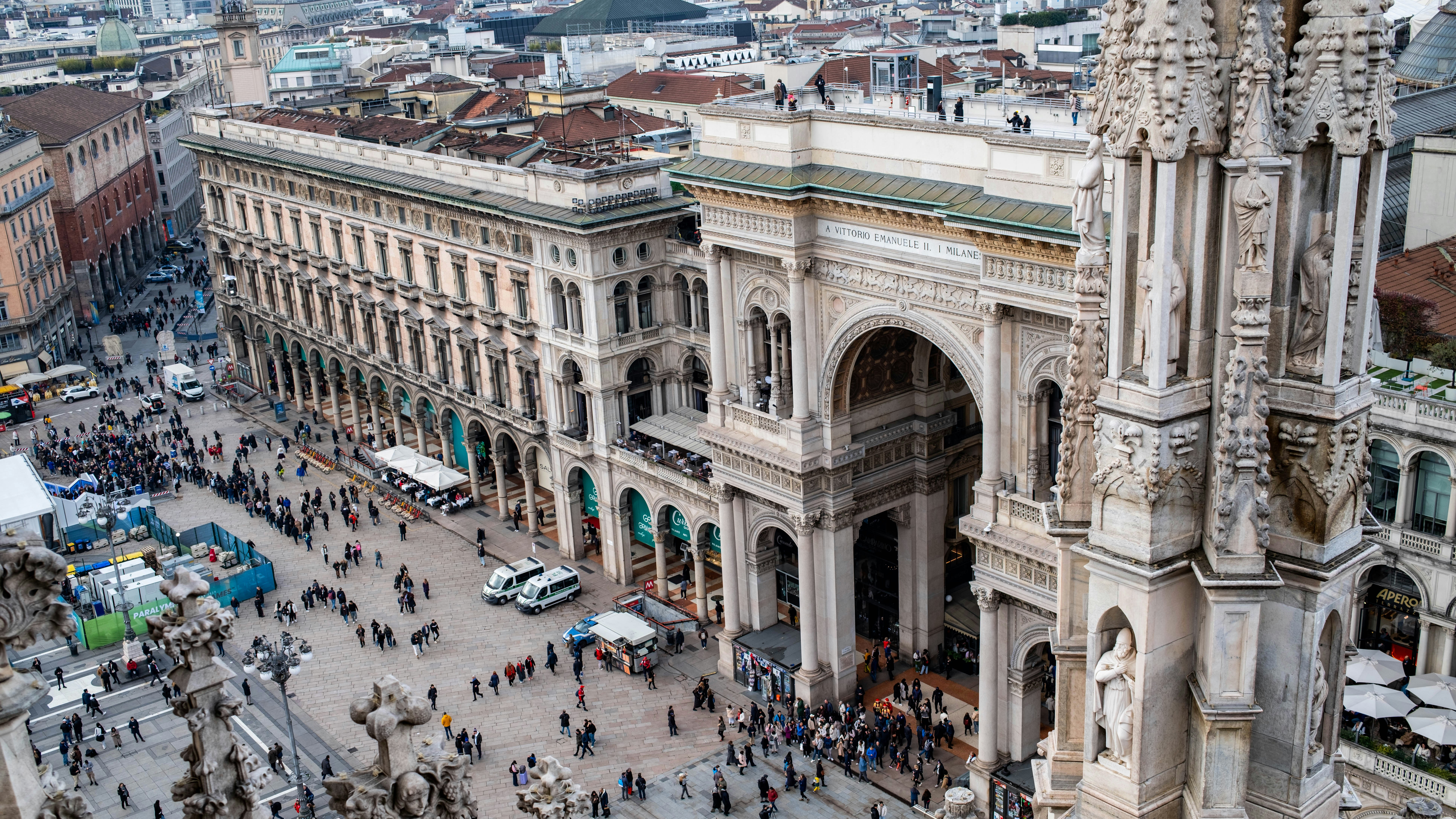 People walking in front of grand ornate architecture