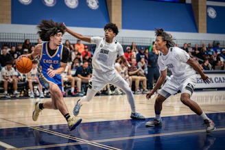 Basketball players competing on a court during a game.
