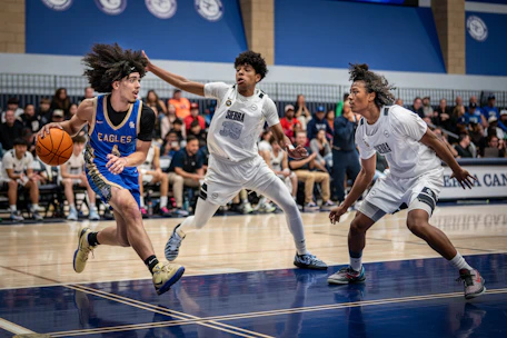 Basketball players competing on a court during a game.