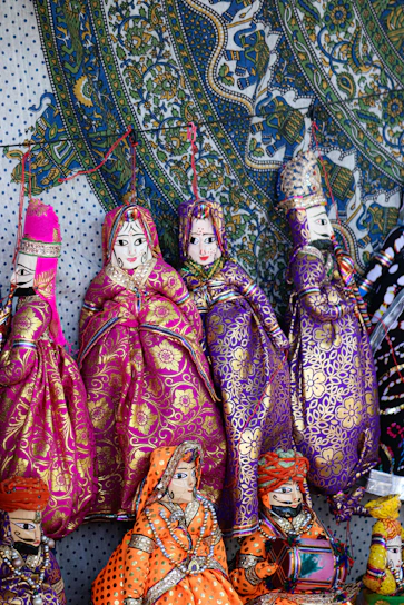 Colorful traditional indian puppets displayed on a patterned background