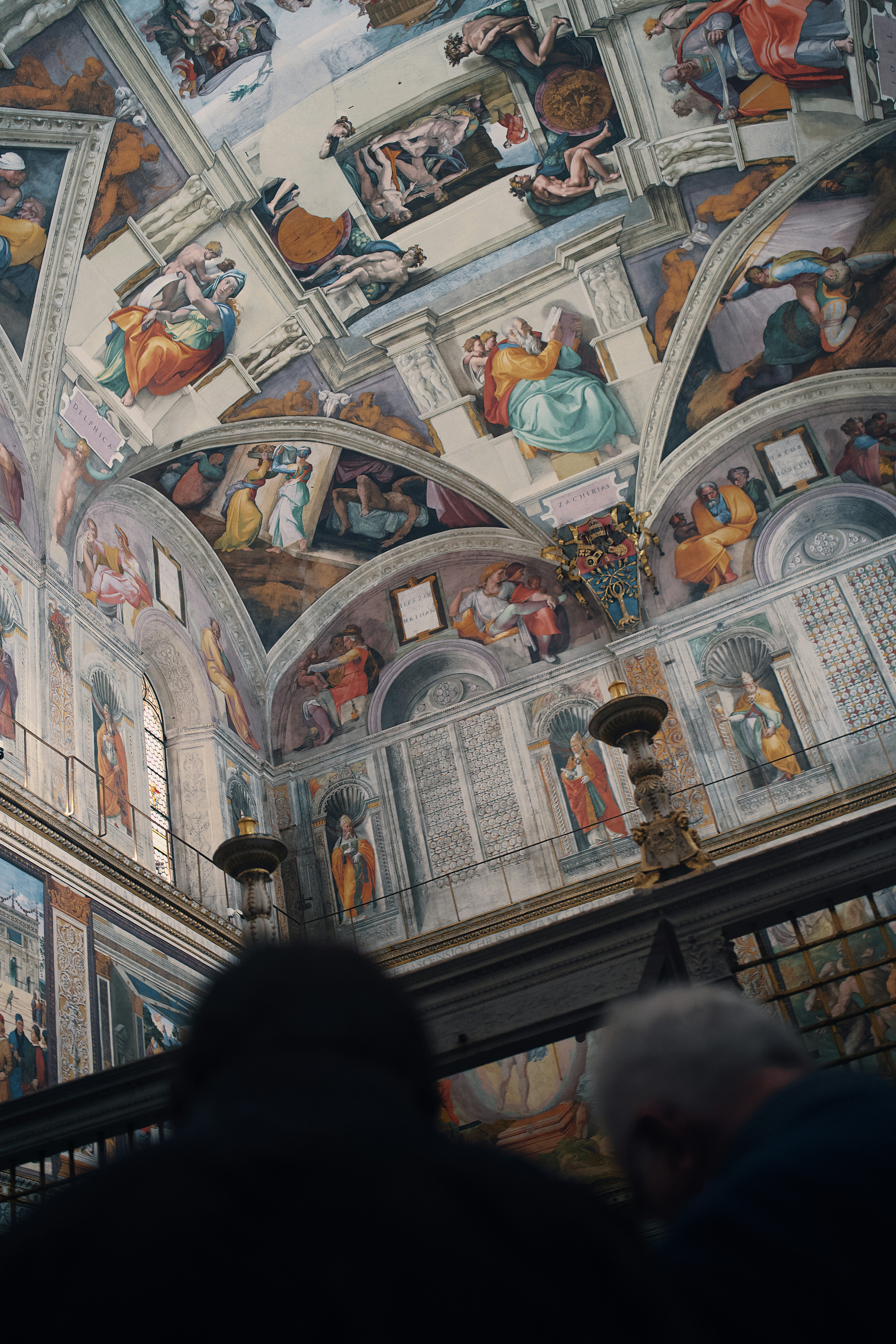 People looking up at the sistine chapel ceiling frescoes.
