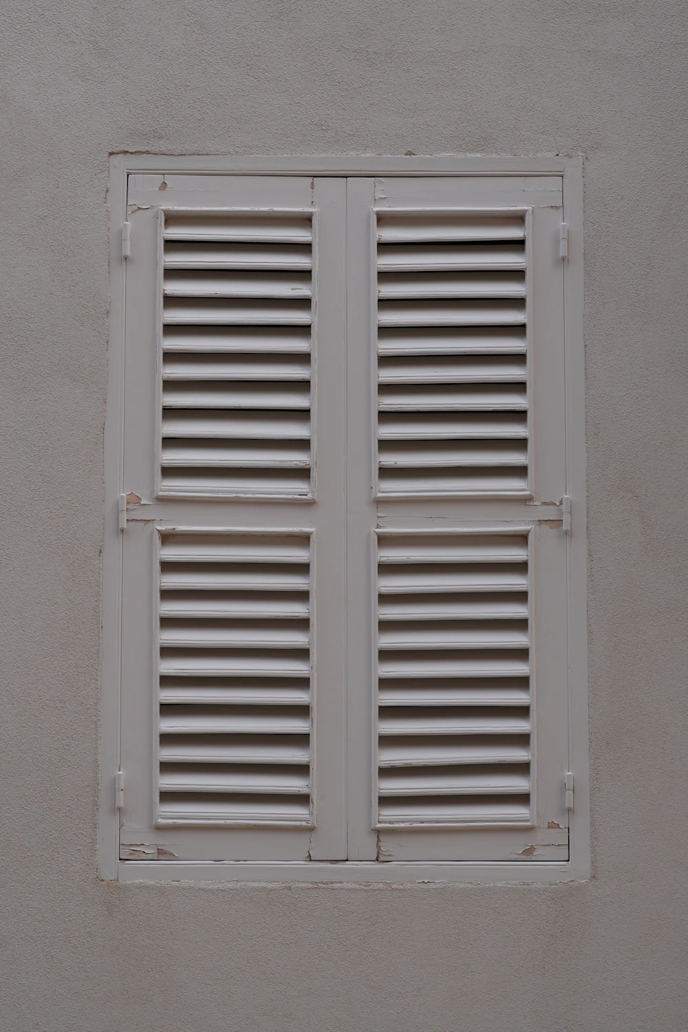 Closed white louvred shutters