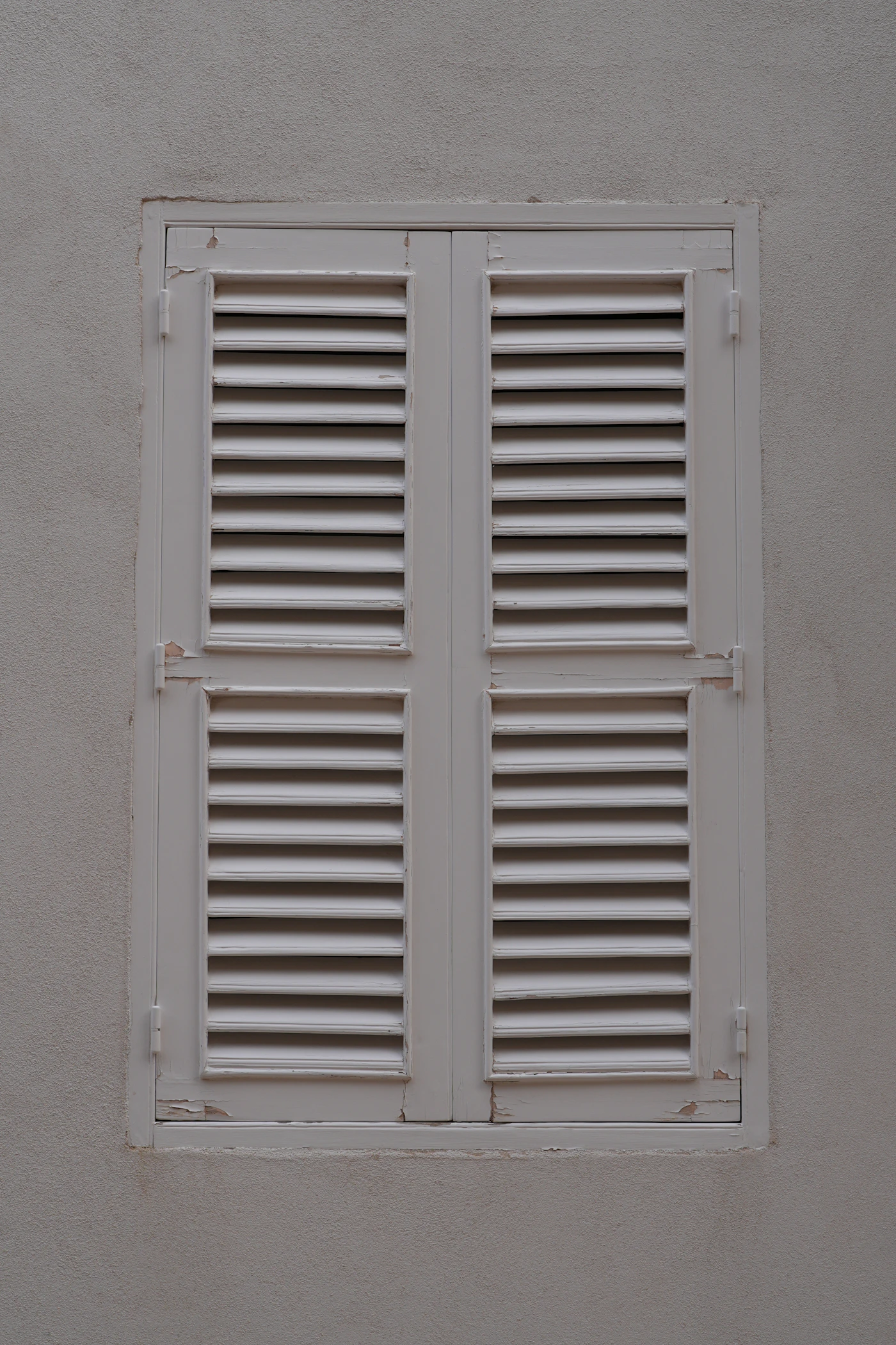 Closed roll-down hurricane shutters protecting a Florida home's openings