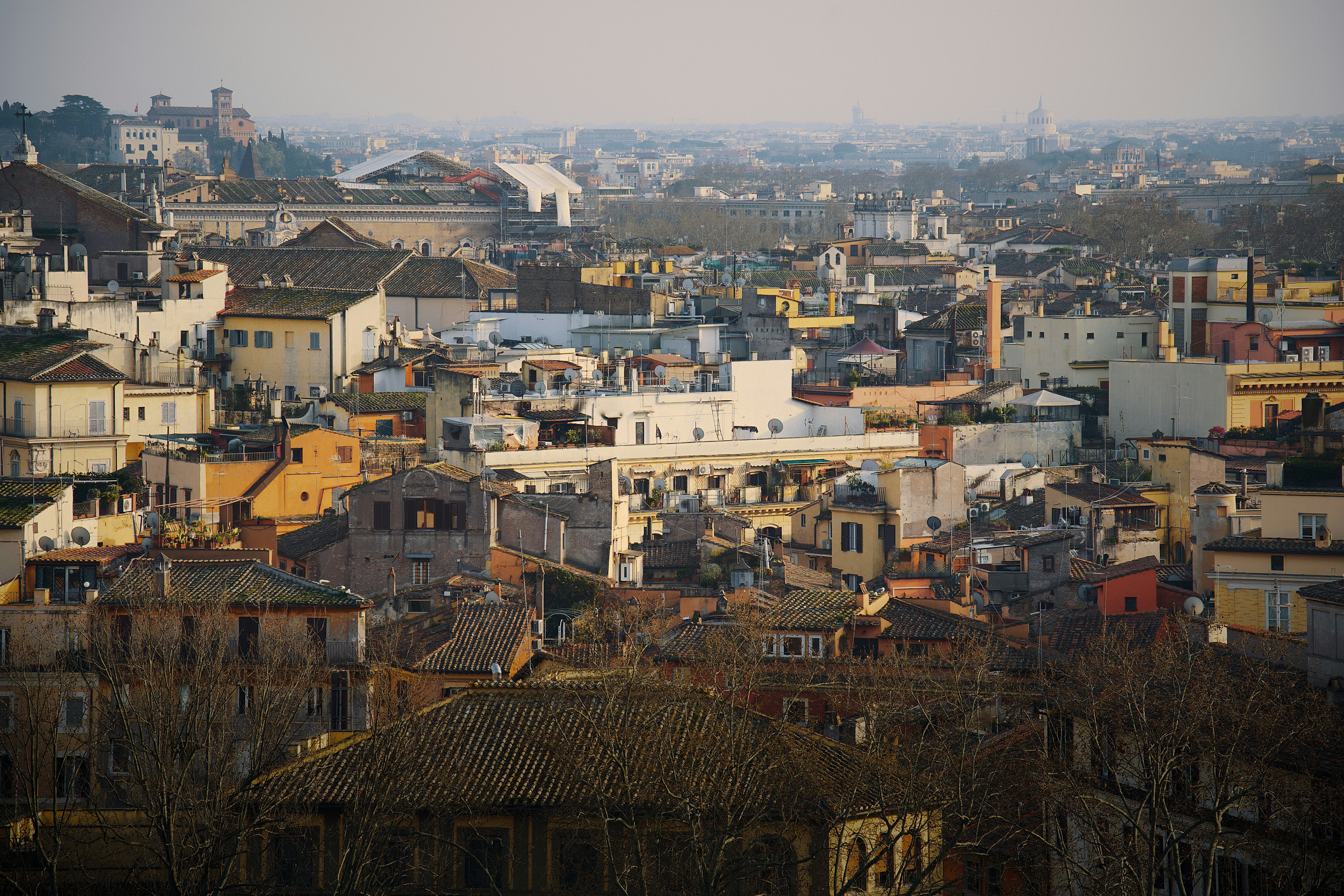 A dense cityscape with many buildings under hazy sky