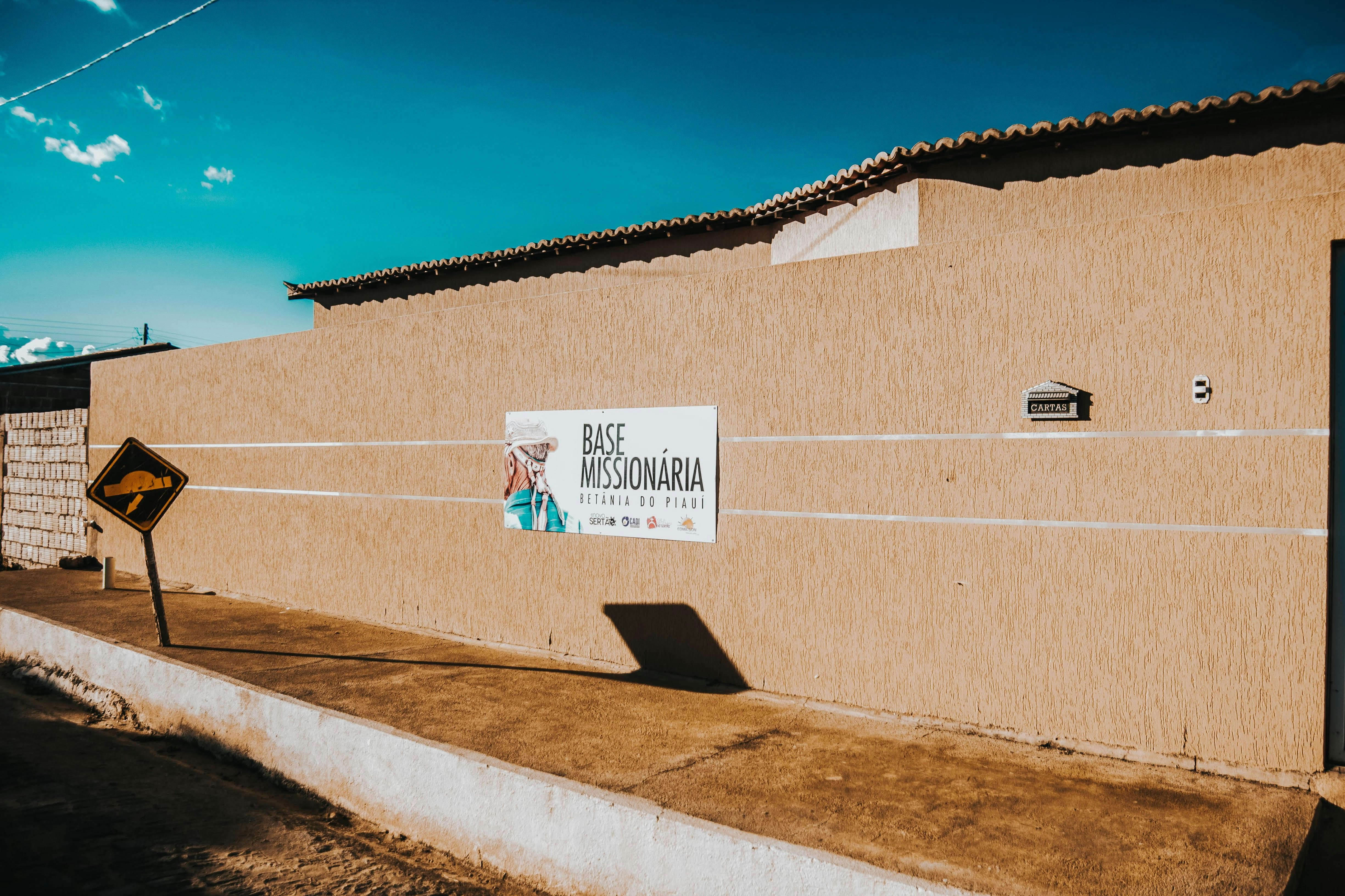 Missionary base building with a sign on wall.