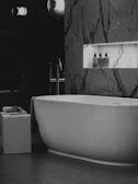 Modern bathroom with freestanding bathtub and marble accents