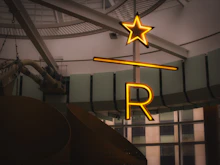 Neon star and letter r sign indoors