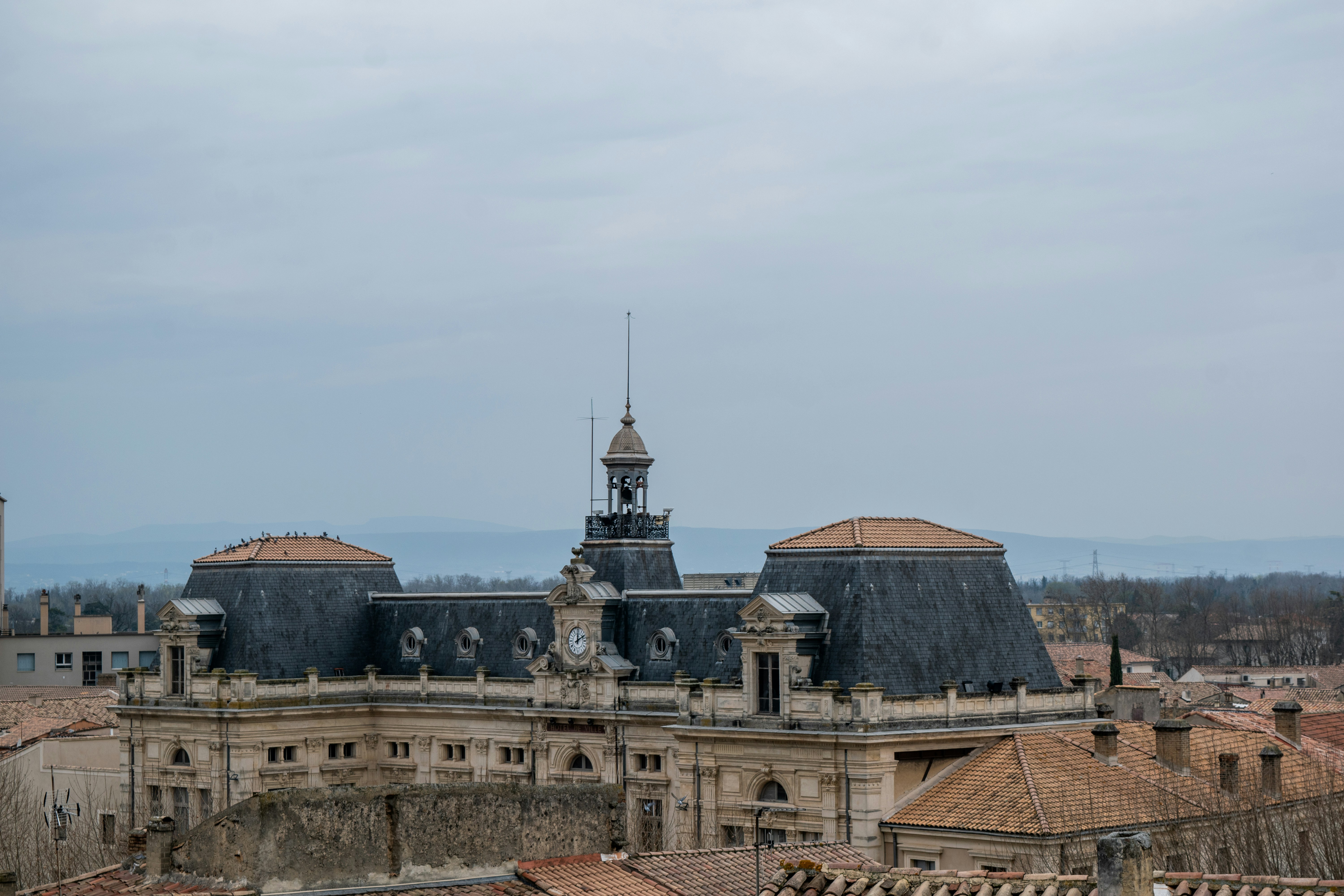 Historic building with domed roofs under cloudy sky