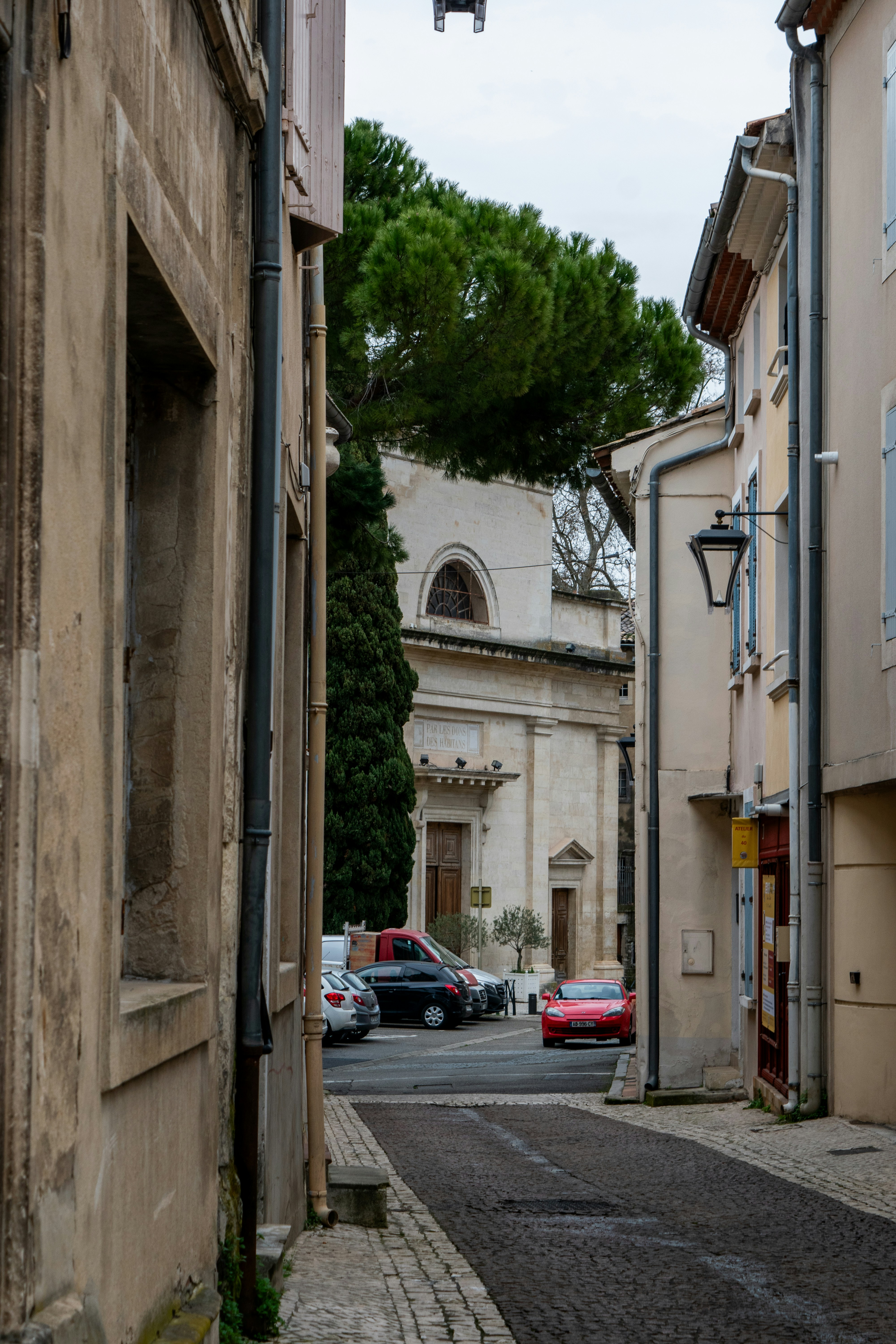 Narrow european street with cars and building