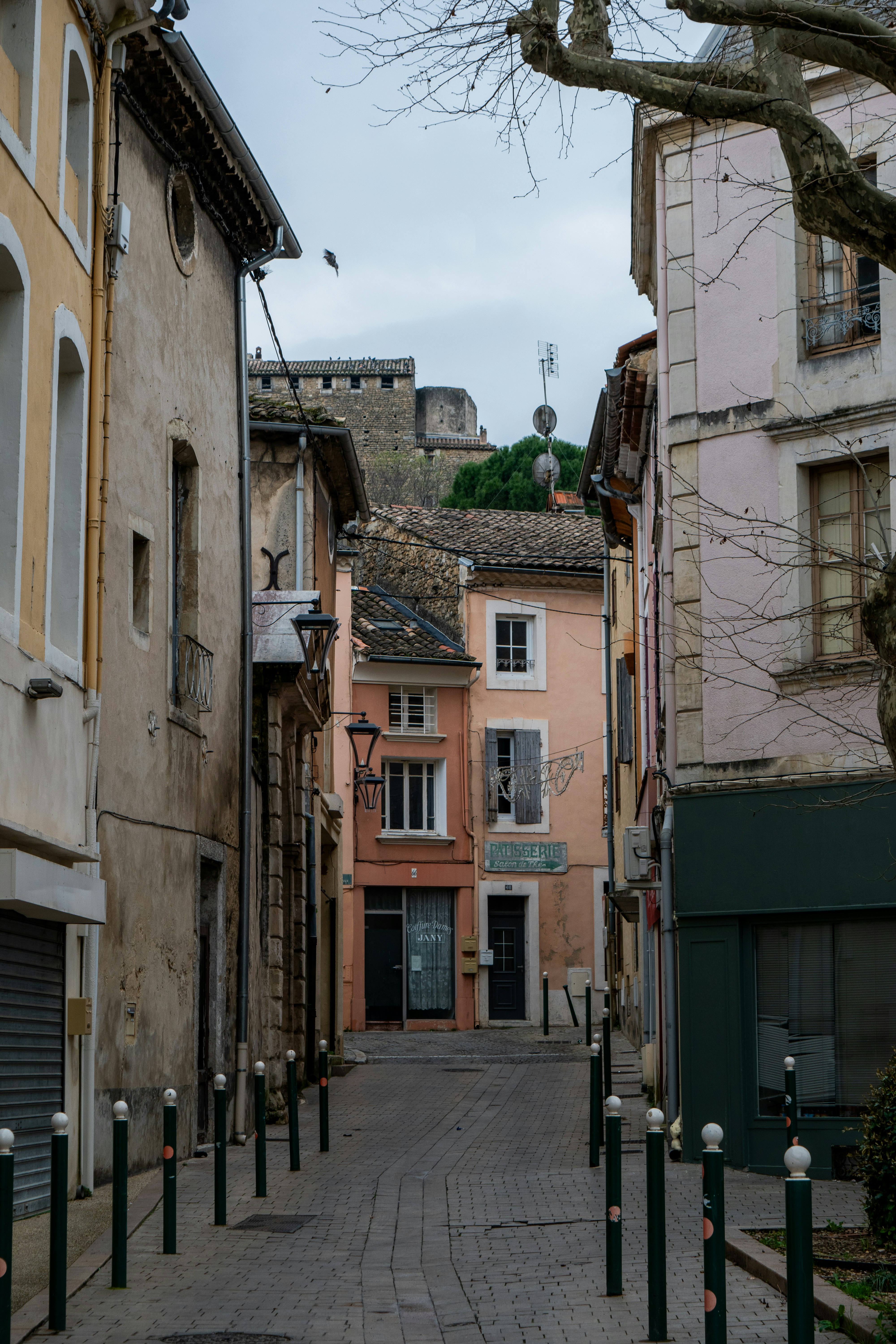 Narrow european street with old buildings and cobblestones