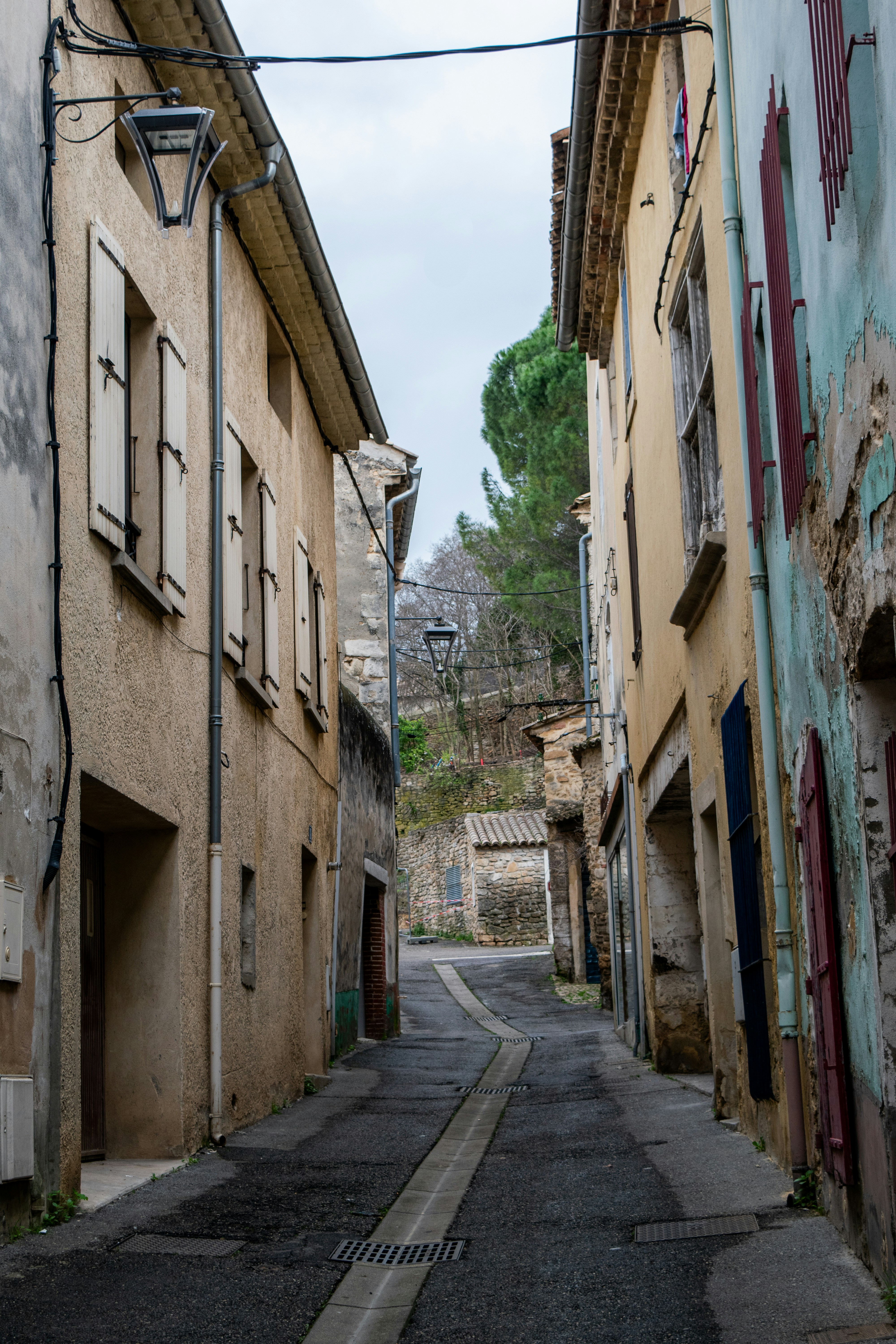 Narrow european street with old buildings and shutters