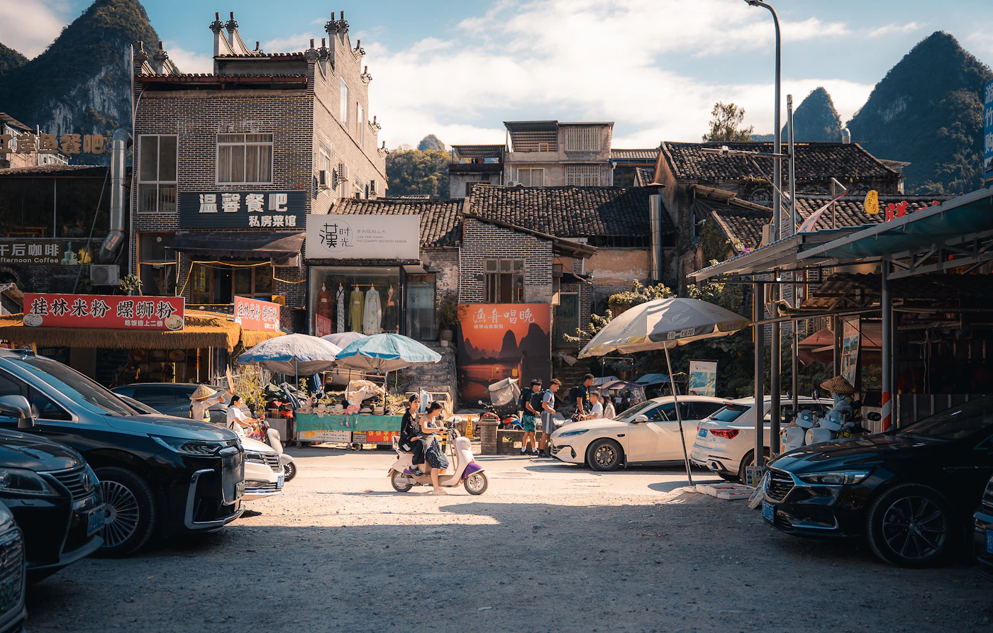 A scooter passing through a small mountain town