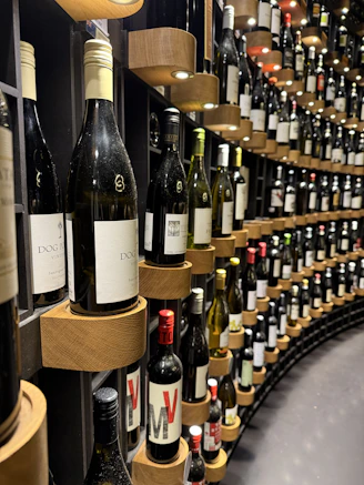 Bottles of wine displayed on a curved shelf