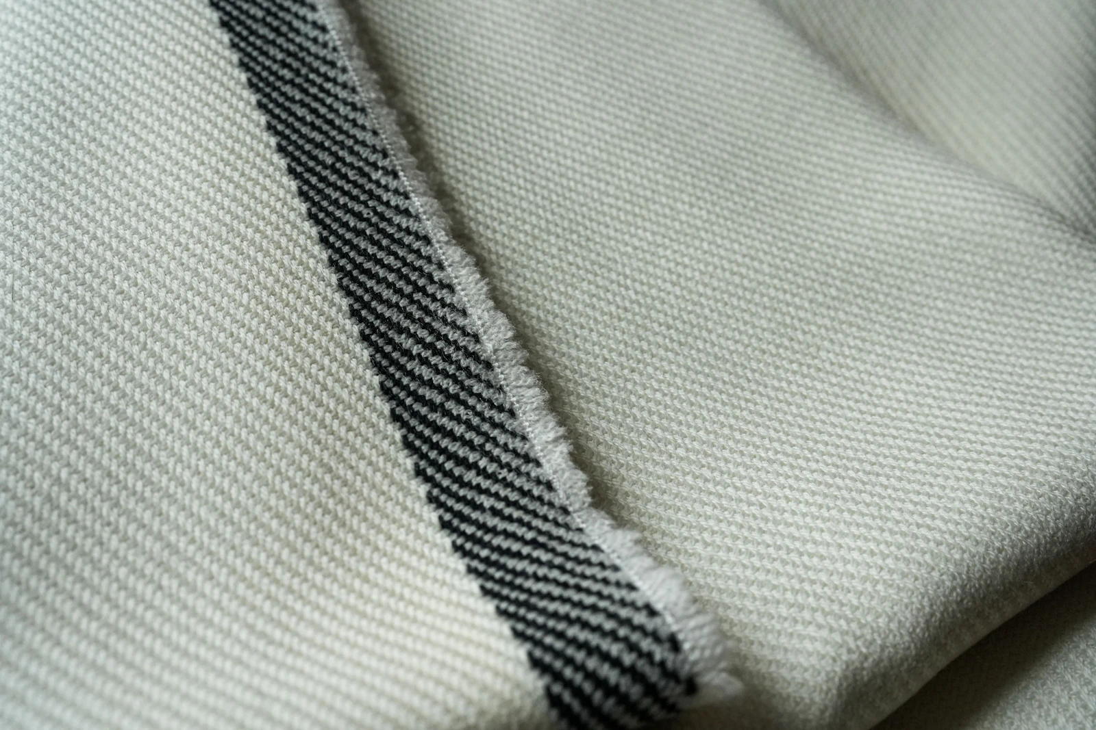 Cream chanderi cloth with a dark striped selvedge