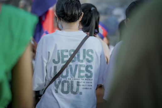 Woman wearing a t-shirt with jesus loves you text