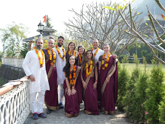 A group of people wearing traditional indian attire outdoors.