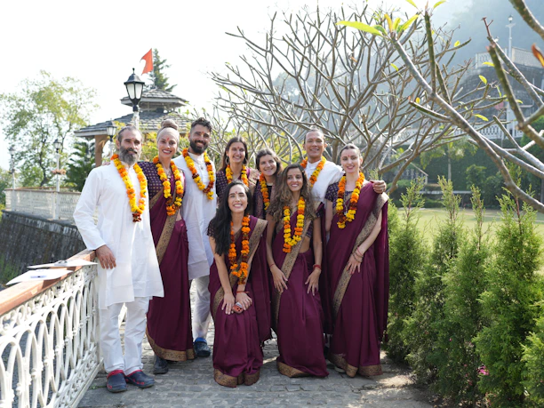 A group of people wearing traditional indian attire outdoors.
