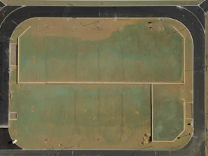 Aerial view of a dusty, green athletic field.