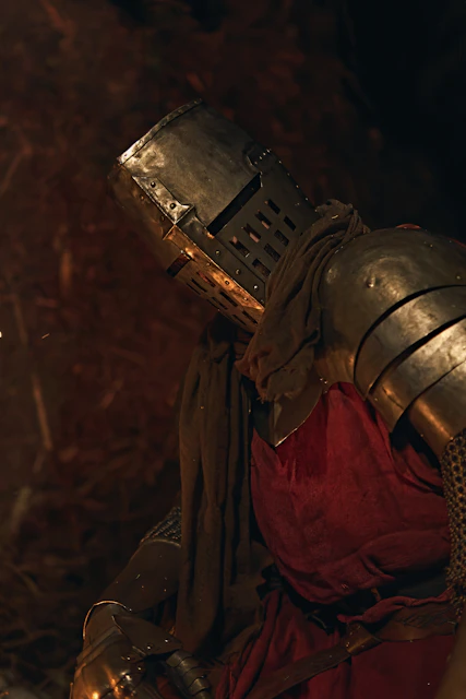 Knight in full armor with red tunic and helmet.