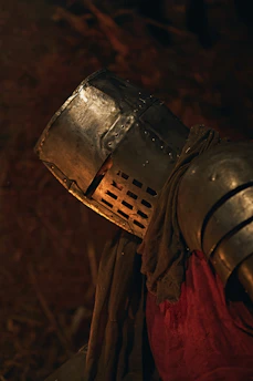 Knight in armor with helmet and red tunic