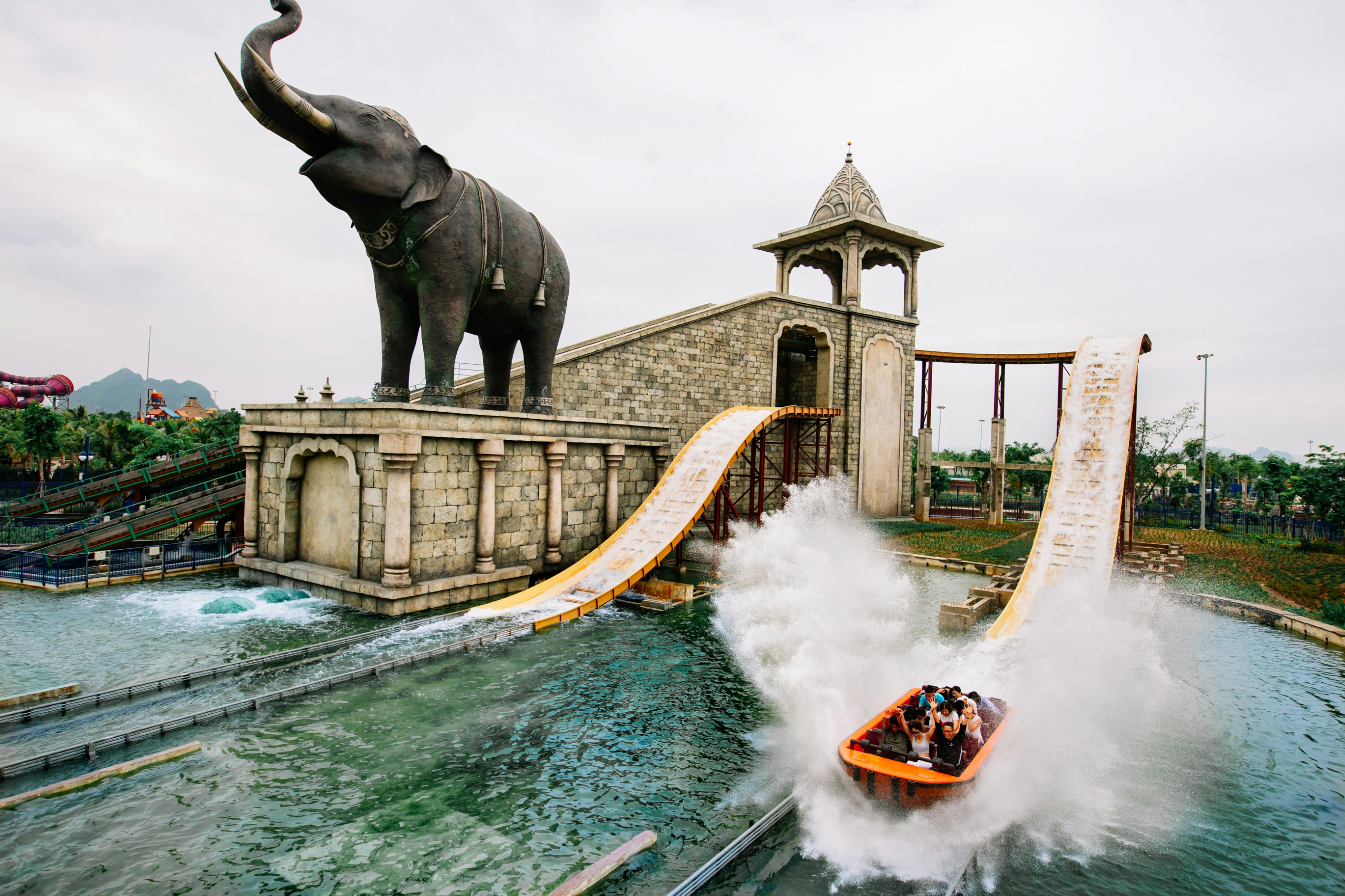 People on a water slide with elephant statue