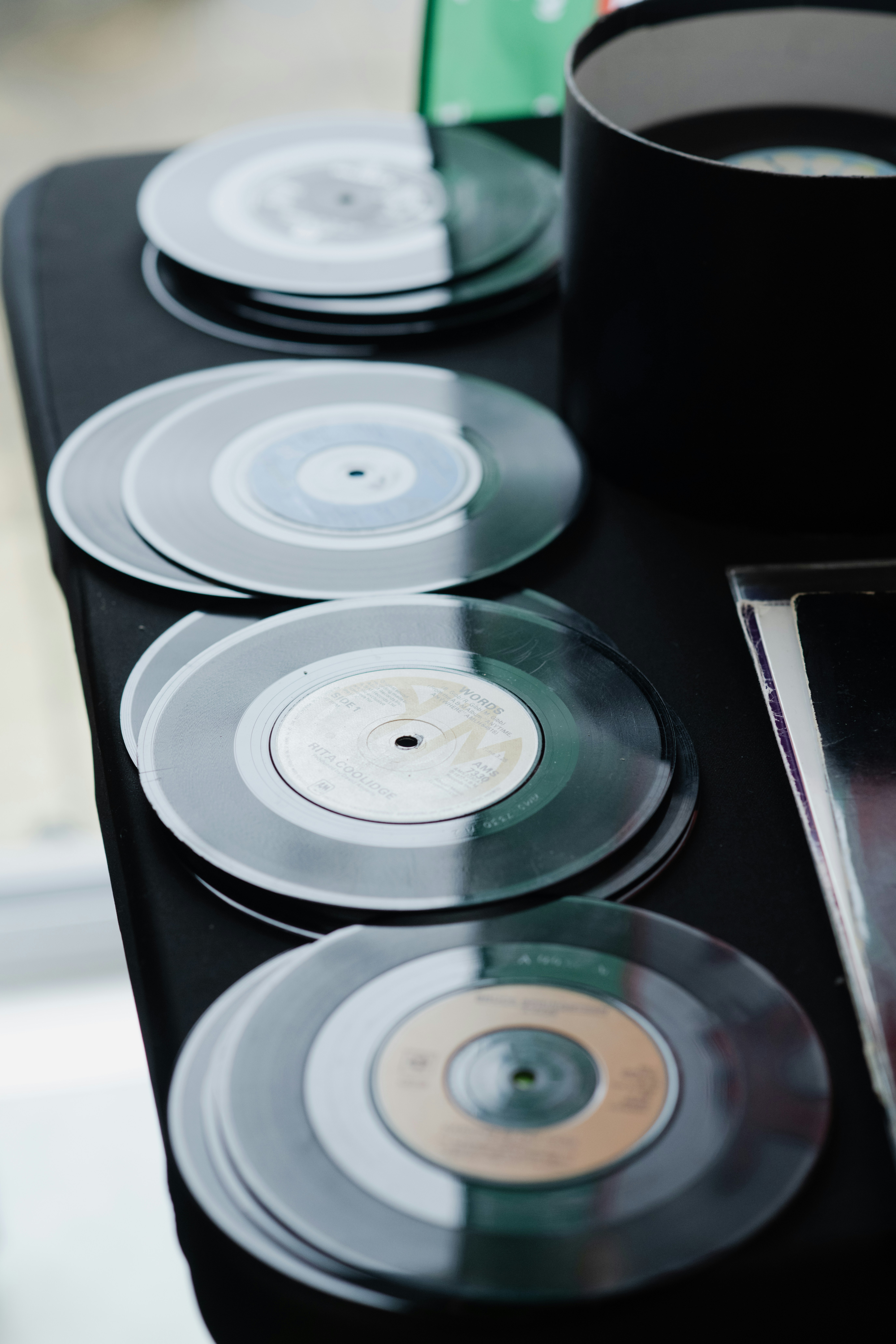 Several vinyl records stacked on a table.